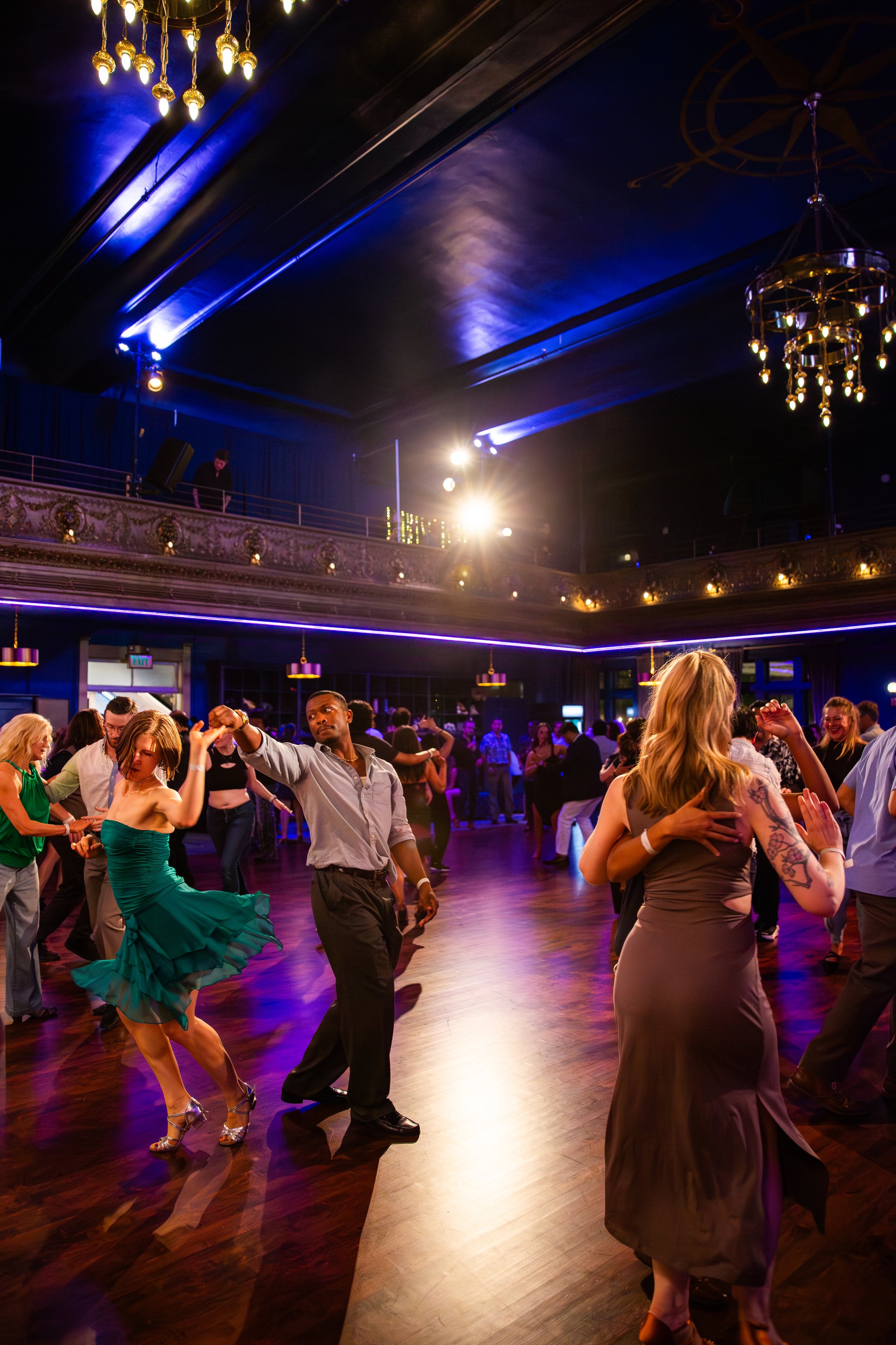 Dancers moving across the floor during a lively dance event in Lisbon, Portugal, captured by a professional event photographer. The energetic atmosphere, expressive movement, and vibrant social setting showcase the excitement of Lisbon’s dance and cu
