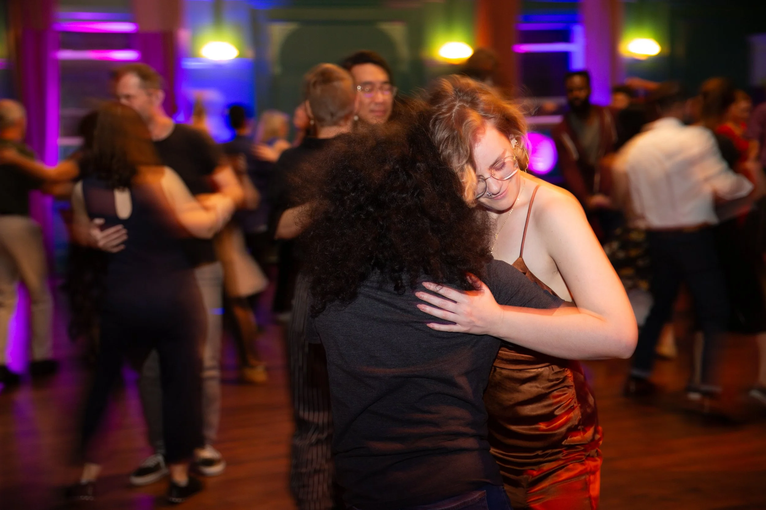 Dancers moving across the floor during a lively dance event in Lisbon, Portugal, captured by a professional event photographer. The energetic atmosphere, expressive movement, and vibrant social setting showcase the excitement of Lisbon’s dance and cu