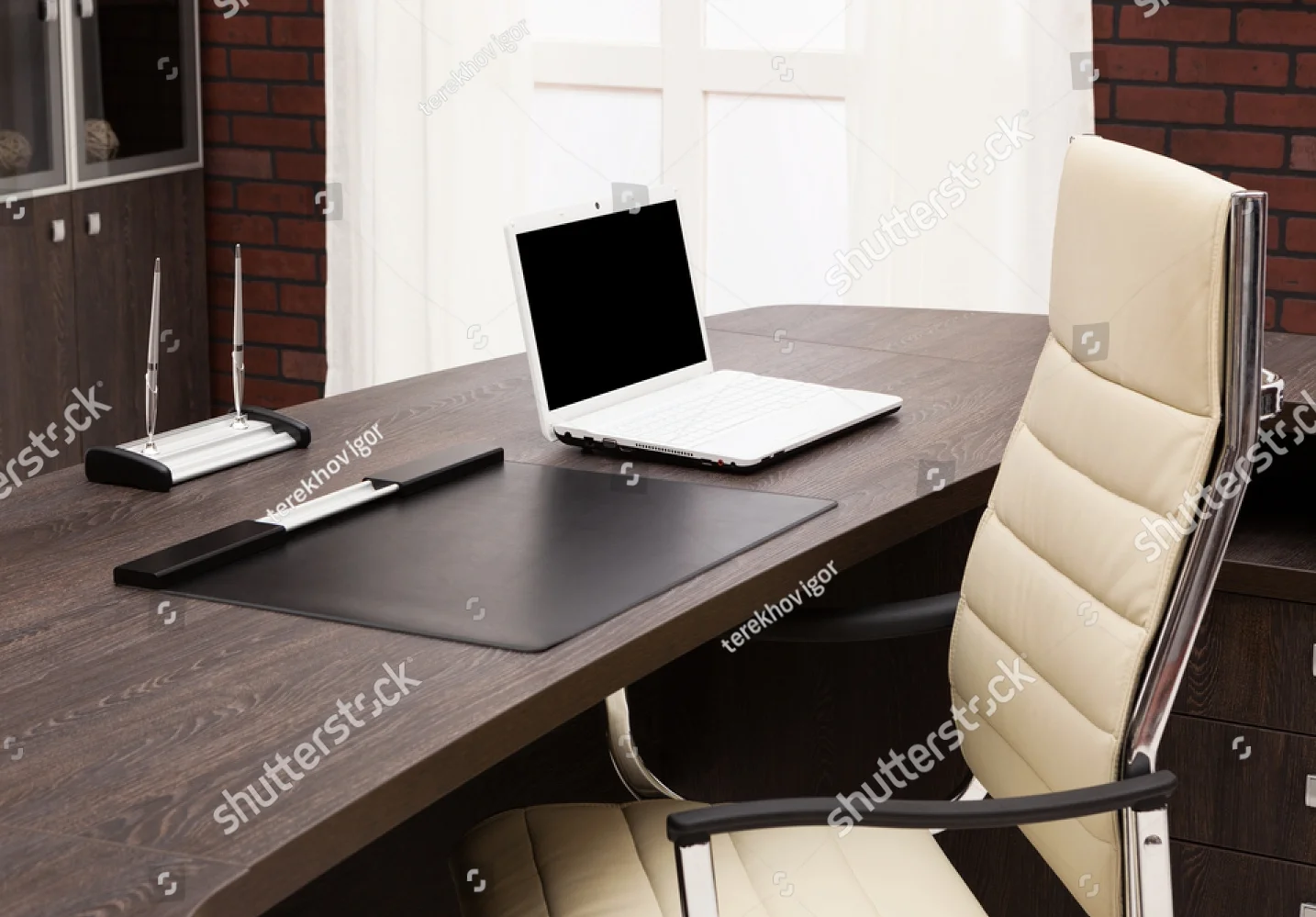stock-photo-laptop-on-a-desk-in-a-modern-office-111215162.jpg