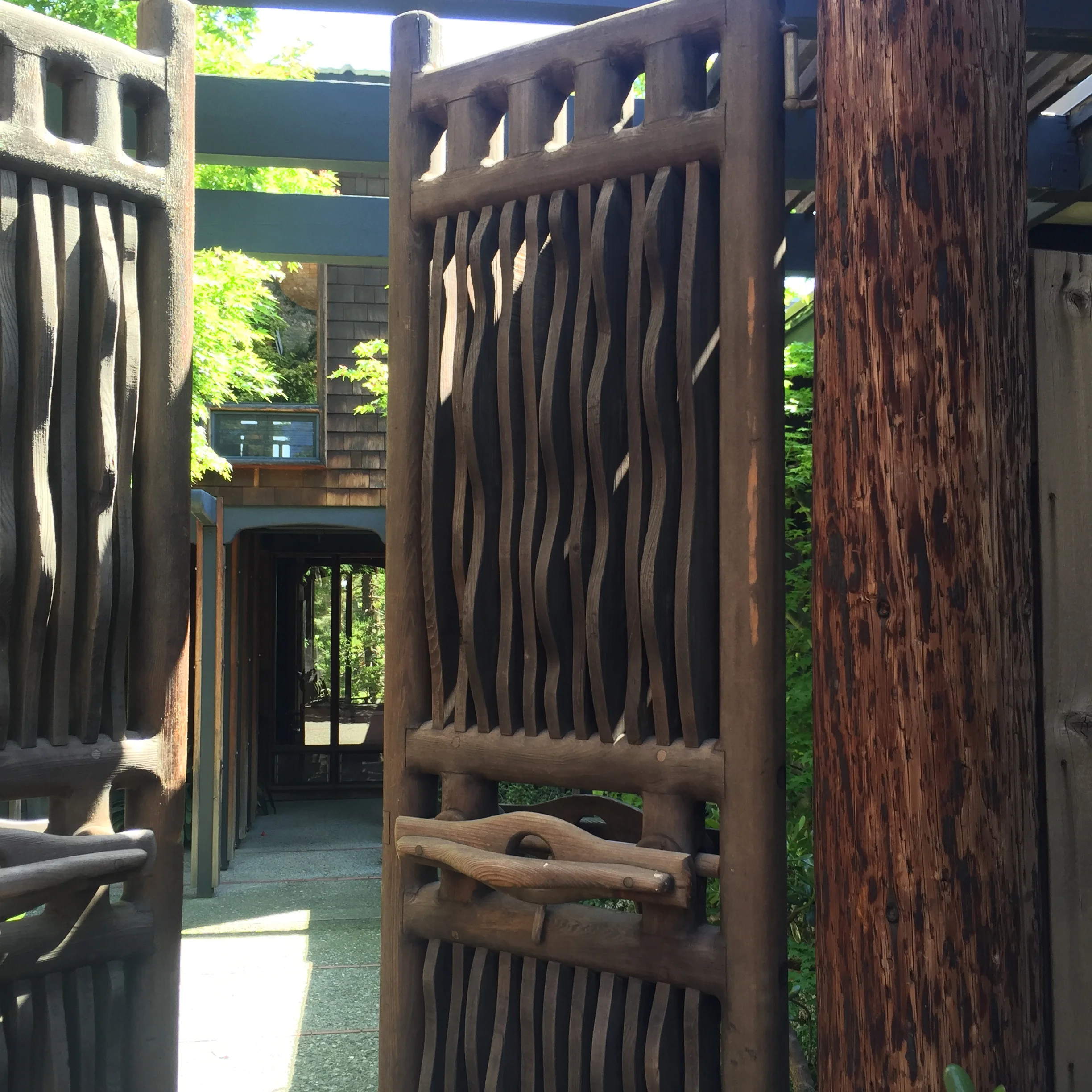 one of several artful entrances that Maloof crafted through the gardens and his house