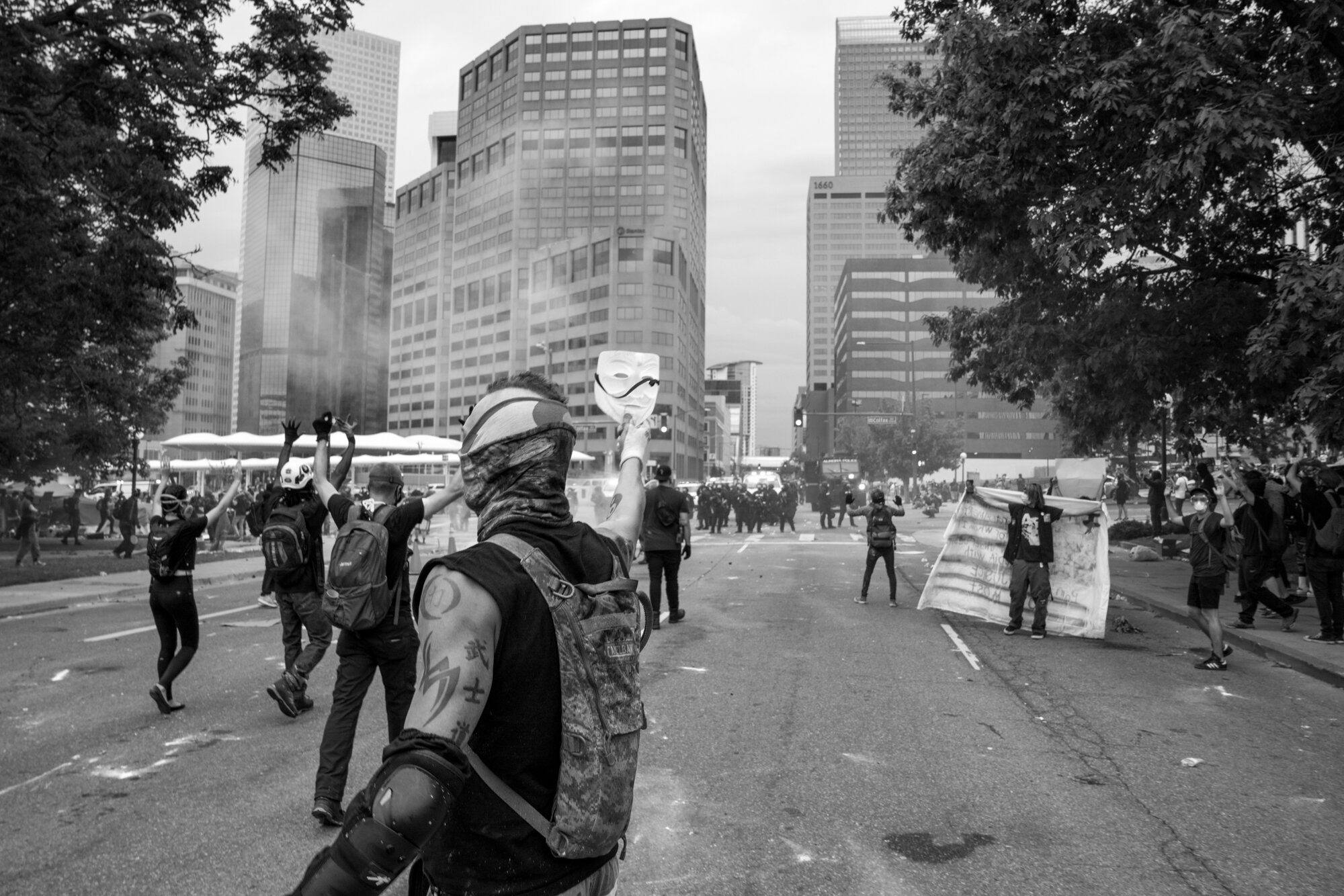 Protesters react after rubber bullets and tear gas were fired in their direction. The man who is holding up the mask was just sprayed with pepper spray. 5/30/2020.