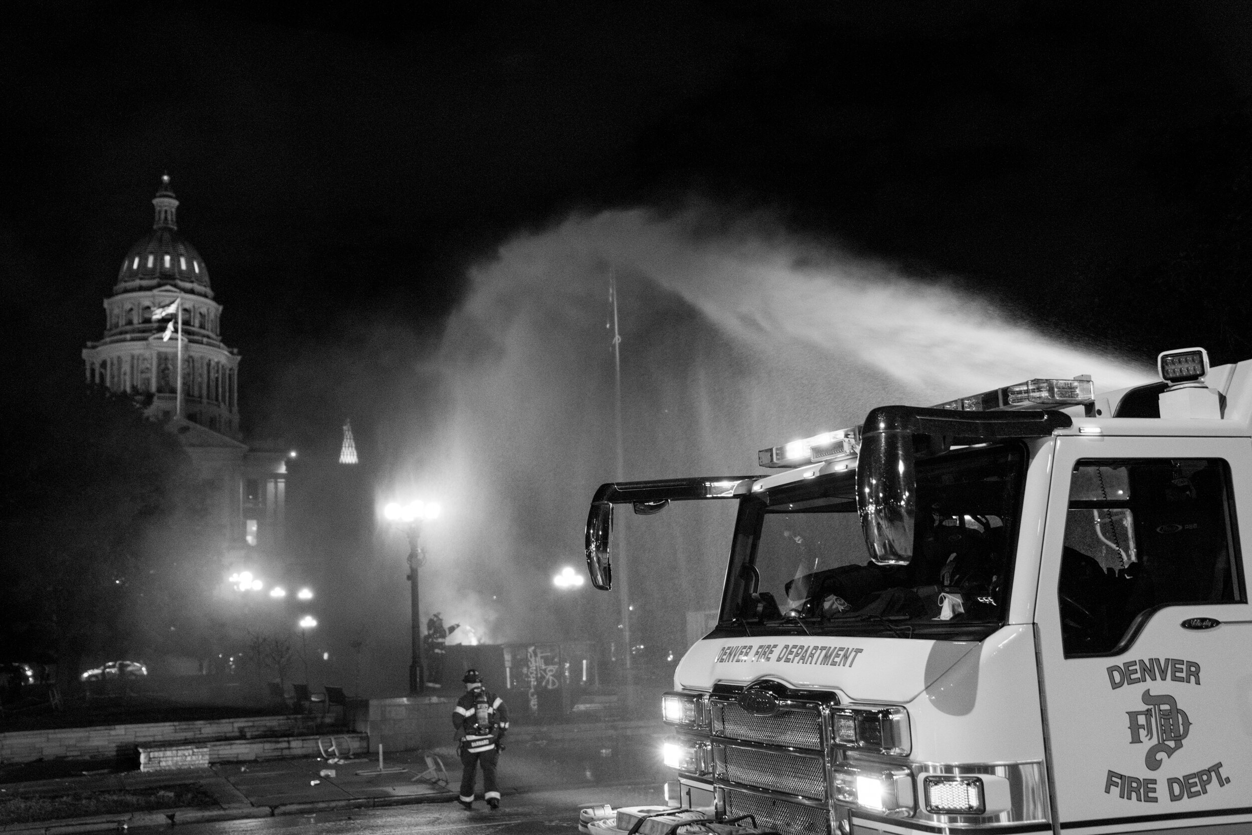 Denver firefighters put out a dumpster fire that was started in font of the state capitol building. 5/29/2020.