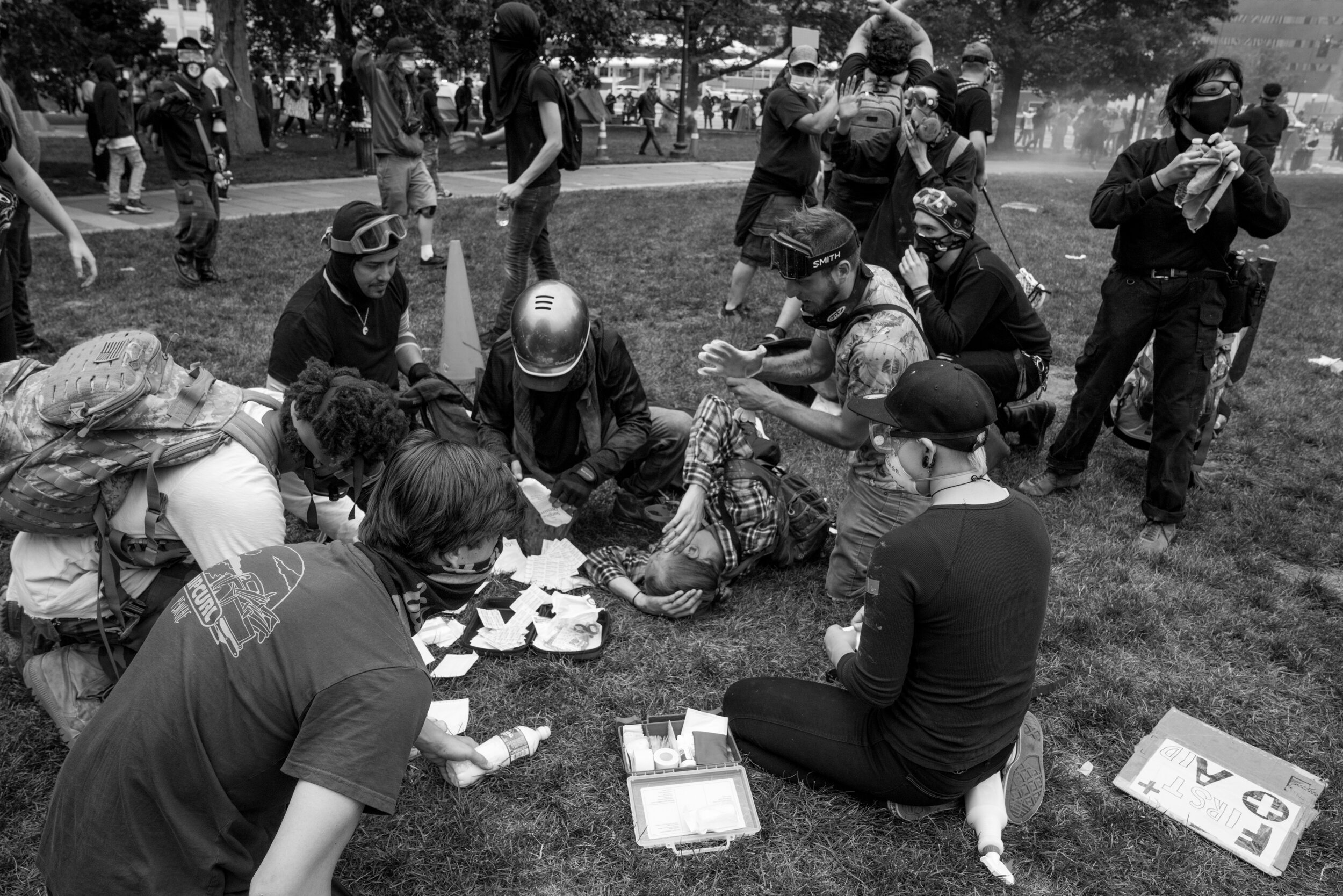 Protesters with medical supplies provide aid to a man who was shot in the face with a rubber bullet. This man ended up having to get his eye removed. 5/30/2020.
