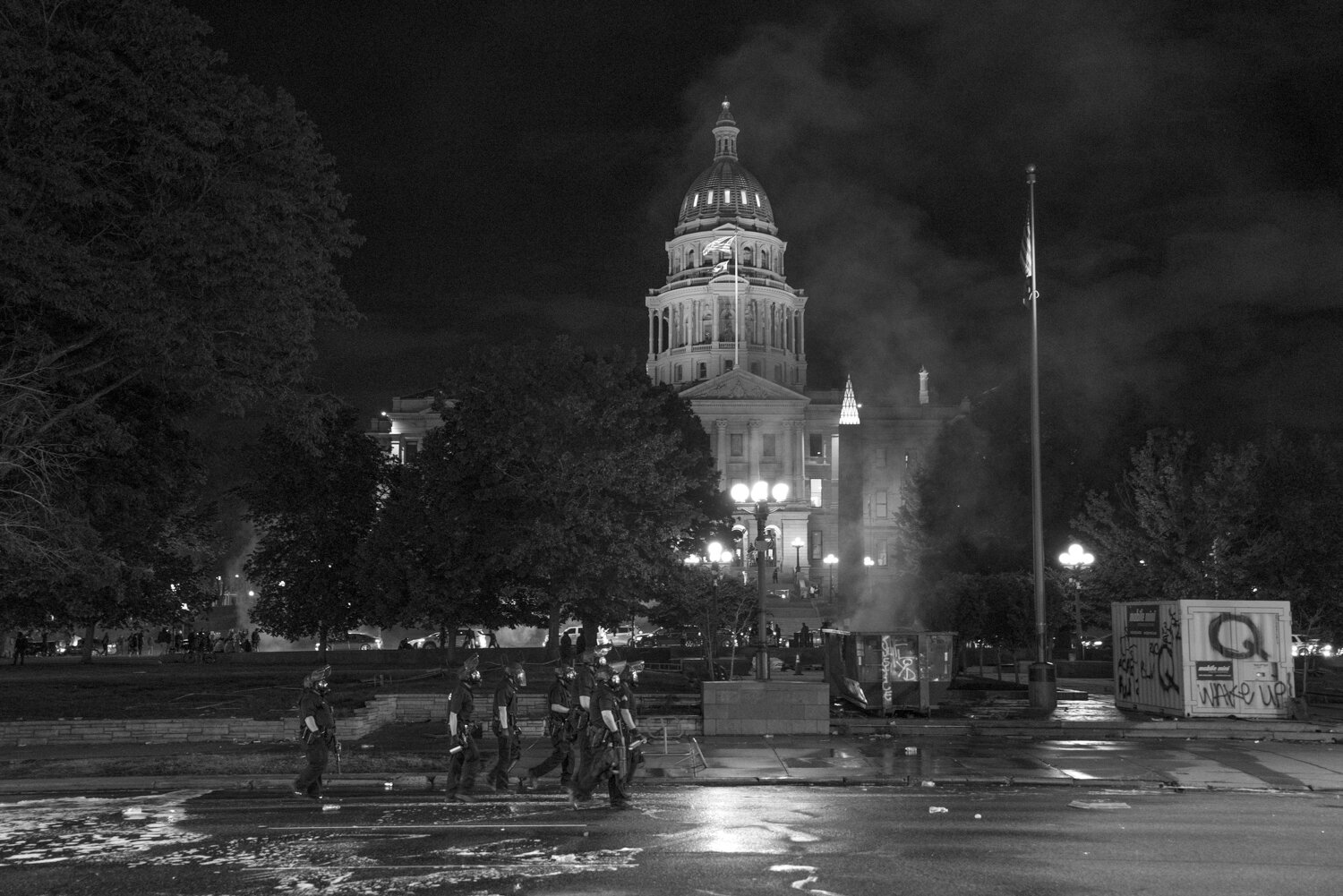 Police walk towards protesters after a fire was recently put out by the fire department. 5/29/2020.