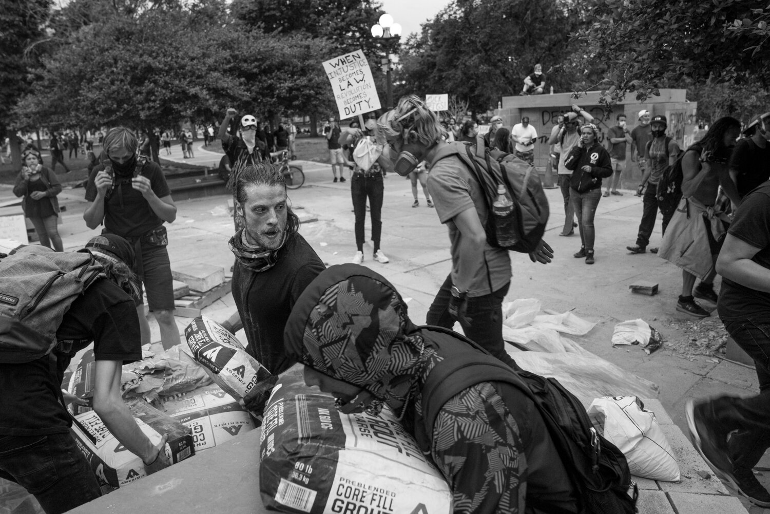 Protesters gather sand bags to reinforce the newly constructed fence. 5/30/2020.