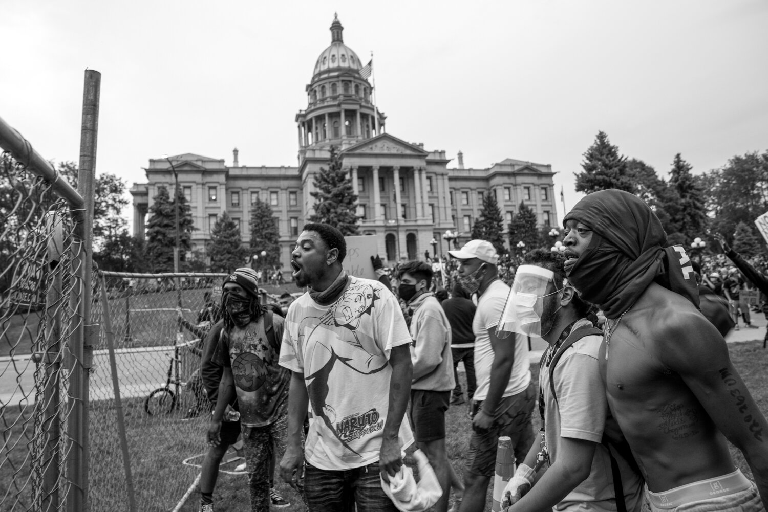 Protesters shout from behind the newly constructed fence just after the curfew started. 5/30/2020.