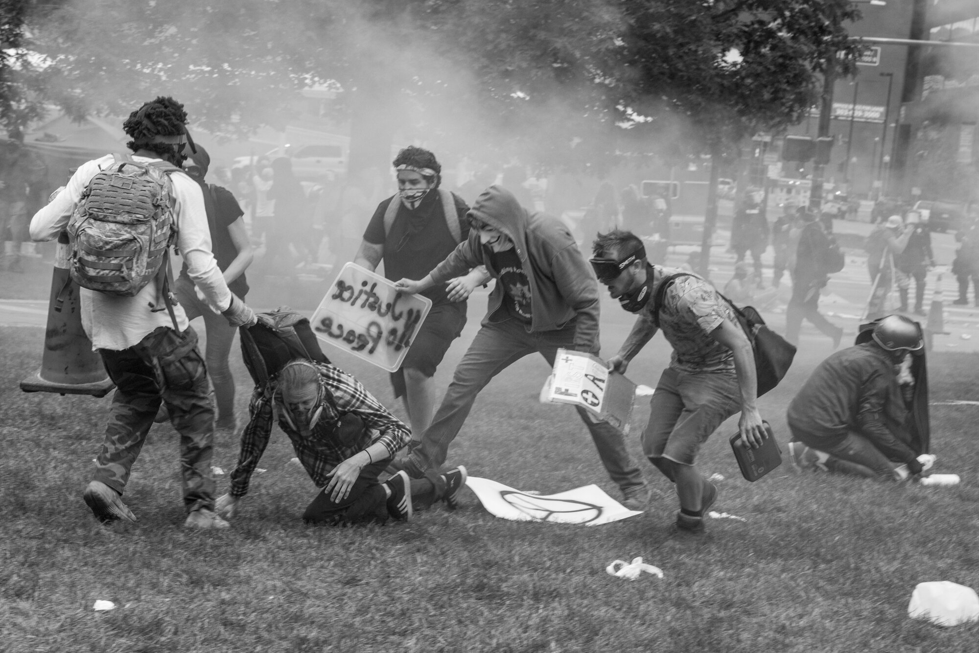 Multiple protesters help pull a man who was hit in the eye with a rubber bullet to safety. 5/30/2020.