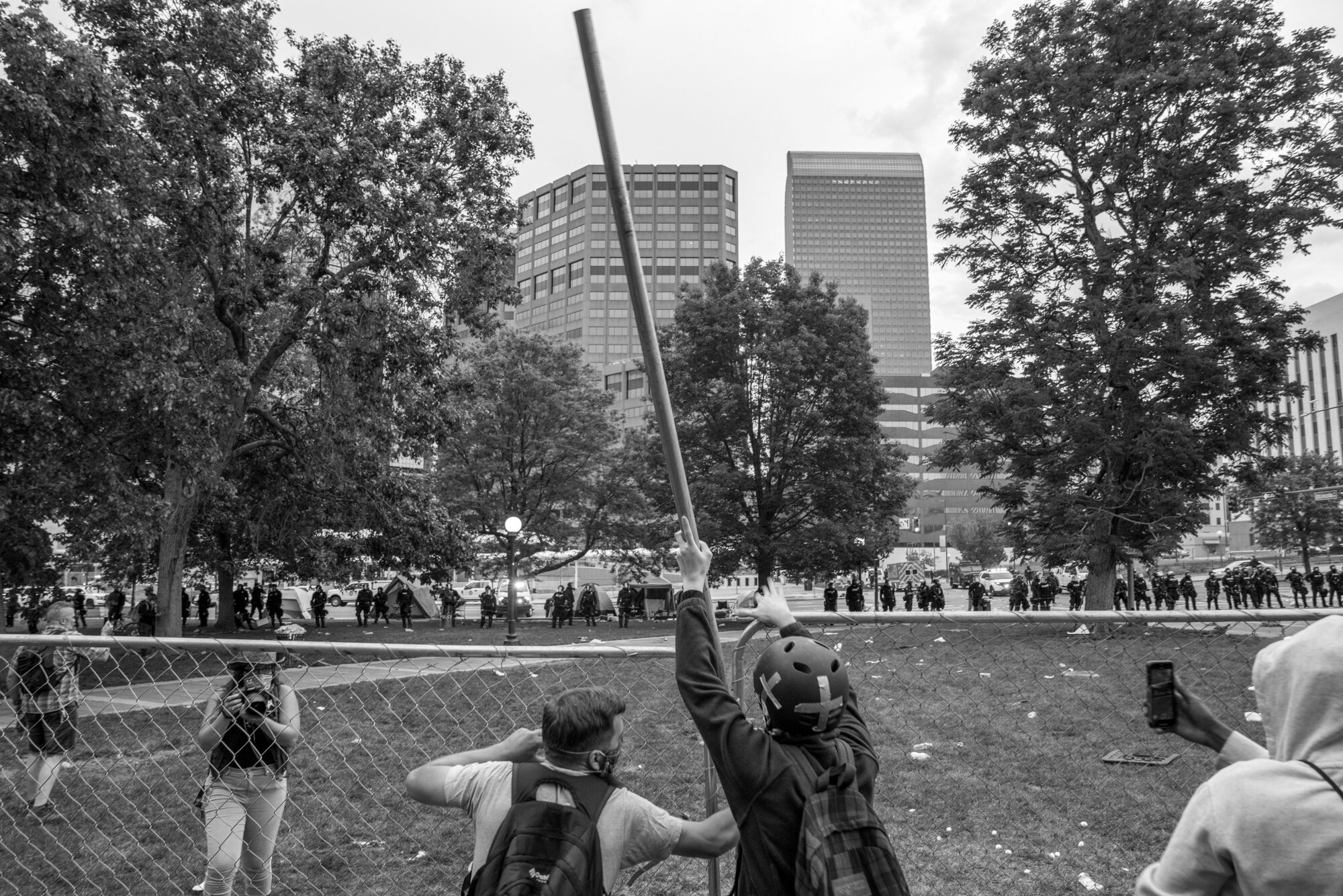 Protesters work together to put the pole in the fence as a city curfew enforced by the national guard was just minutes away from starting. 5/30/2020.