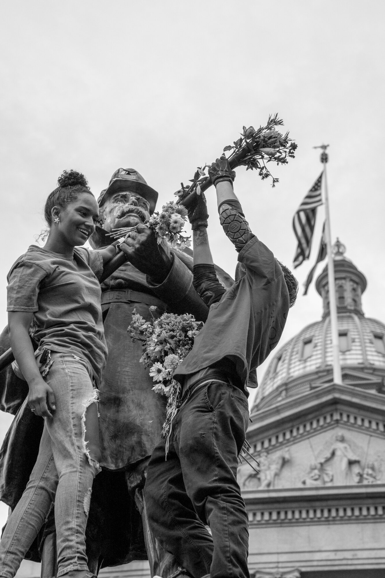 A civil war statue is adorned in flowers by protesters. 6/01/2020.