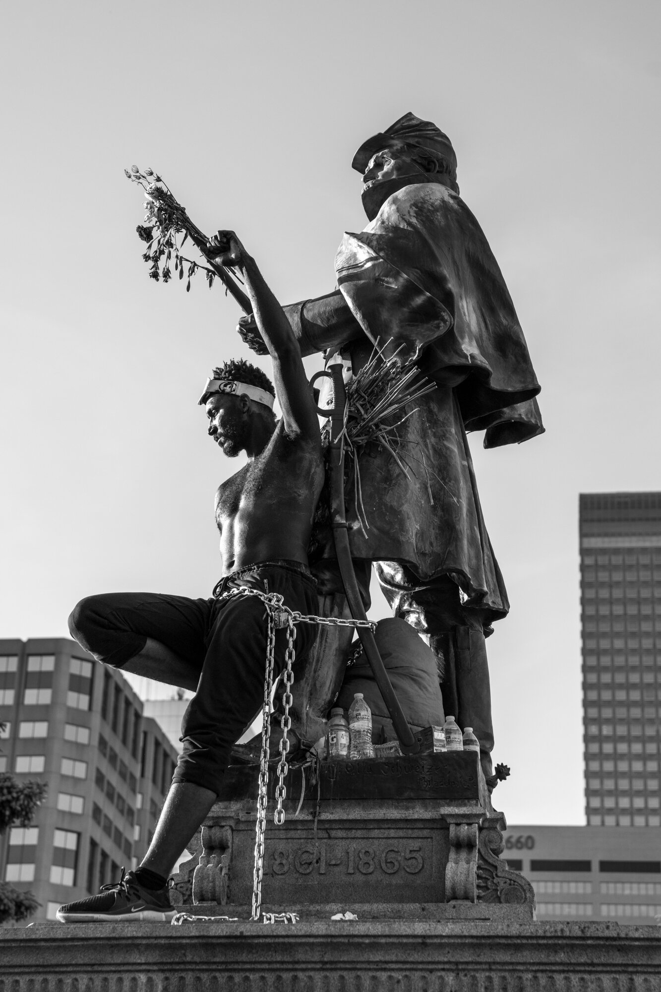 A performance artist chained him self to a civil war statue outside of the Colorado State Capitol Building. 6/02/2020.