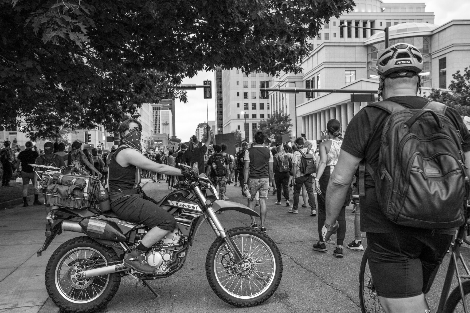 A person on their dirt bike watches as a march starts. 6/02/2020.