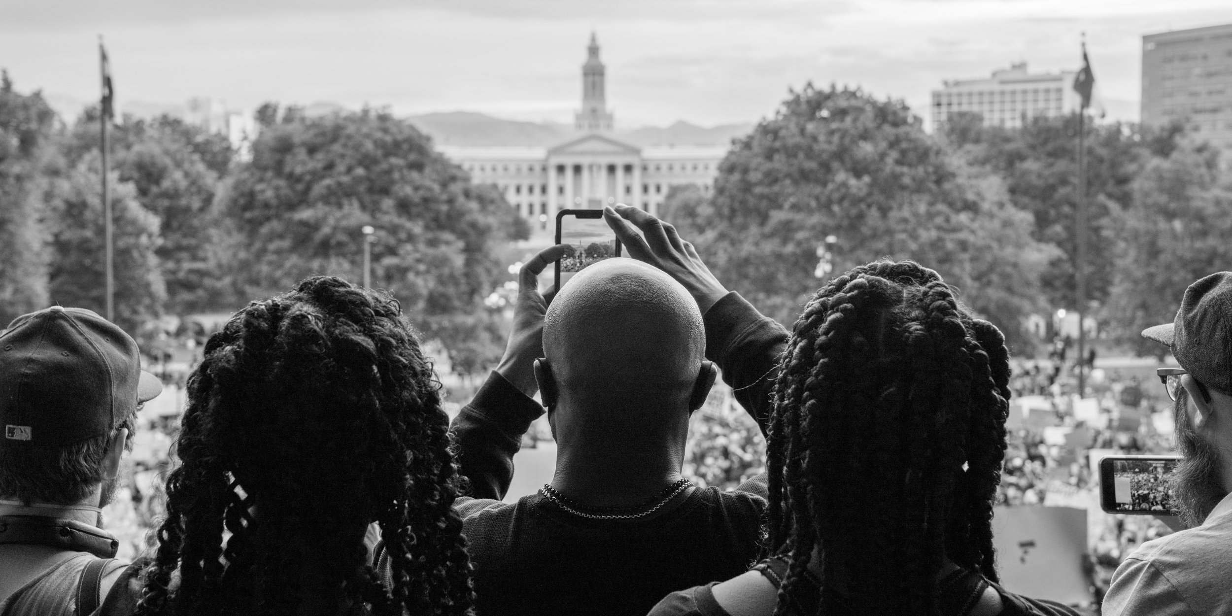 A group of protesters stand on the steps of the capitol while others gather below. 6/01/2020.