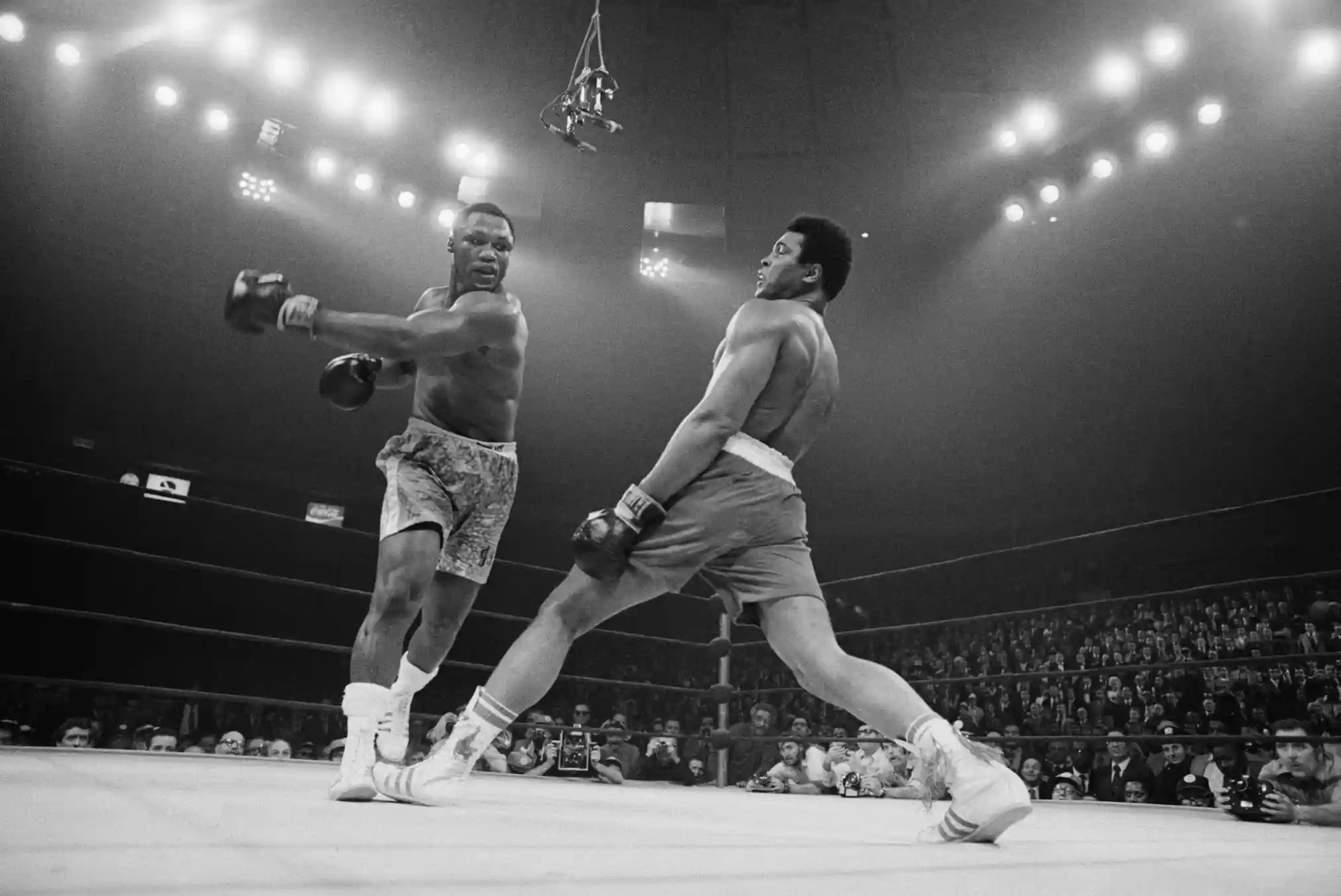 Muhammad Ali steps away from a punch thrown by Joe Frazier. Photograph: Bettmann/Bettmann Archive