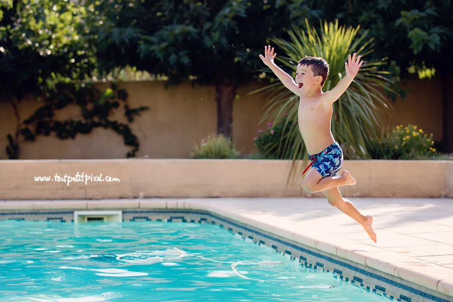 Garçon qui saute dans la piscine
