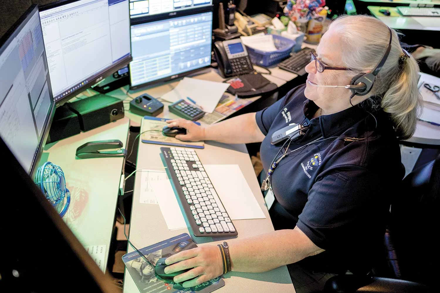 Winchester Police Communications Supervisor Rhonda Rogers answers an emergency call during an early-morning shift. Rogers said the Career Development Program helps transform dispatching from a run-of-the-mill job to a satisfying career. (Photo by Jim Robertson)