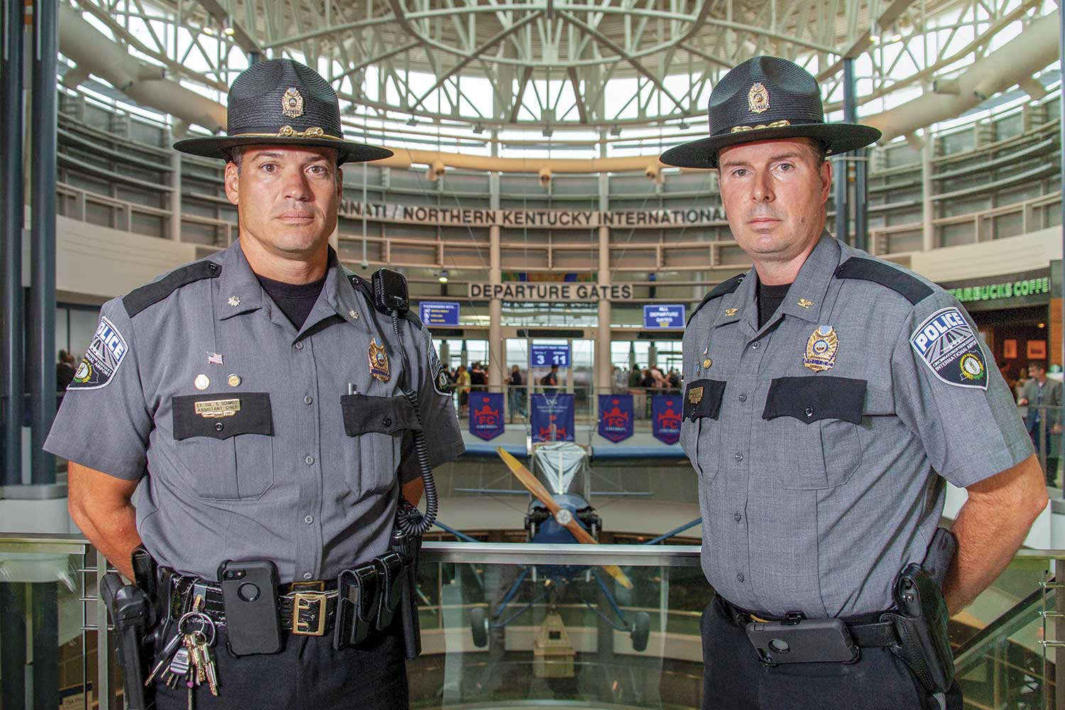  Cincinnati-Northern Kentucky International Airport Police Lt. Col. Steve Schmidt, left, and Chief Shawn Ward pose inside the airport, near the departure gates. (Photo by Jim Robertson) 