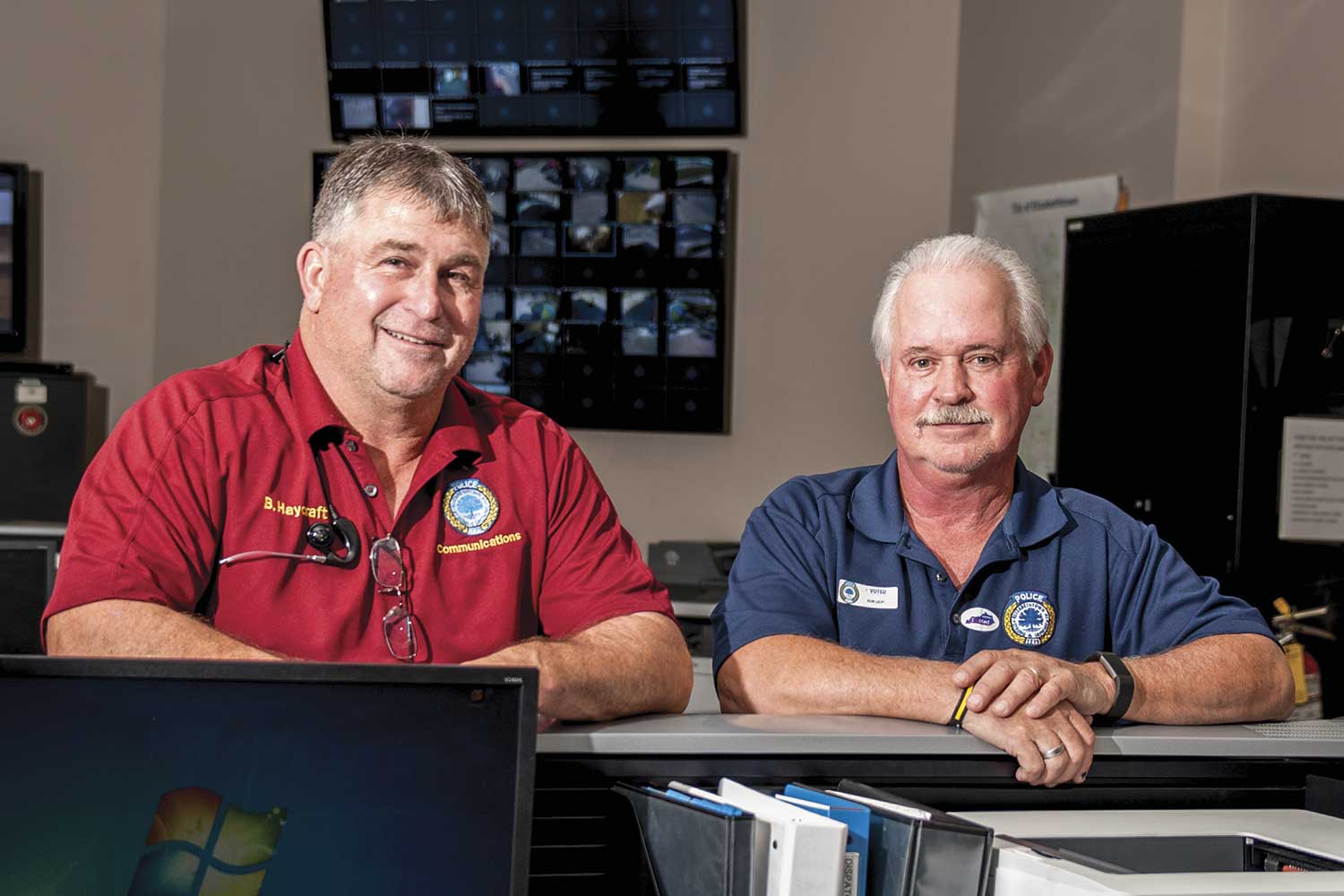  Elizabethtown Police Dispatch Supervisor, Darrell Brangers (right), is the longest-serving EPD employee. Dispatcher Billy Jo Haycraft (left) is just behind Brangers’ record with 36 years of service. (Photo by Jim Robertson) 