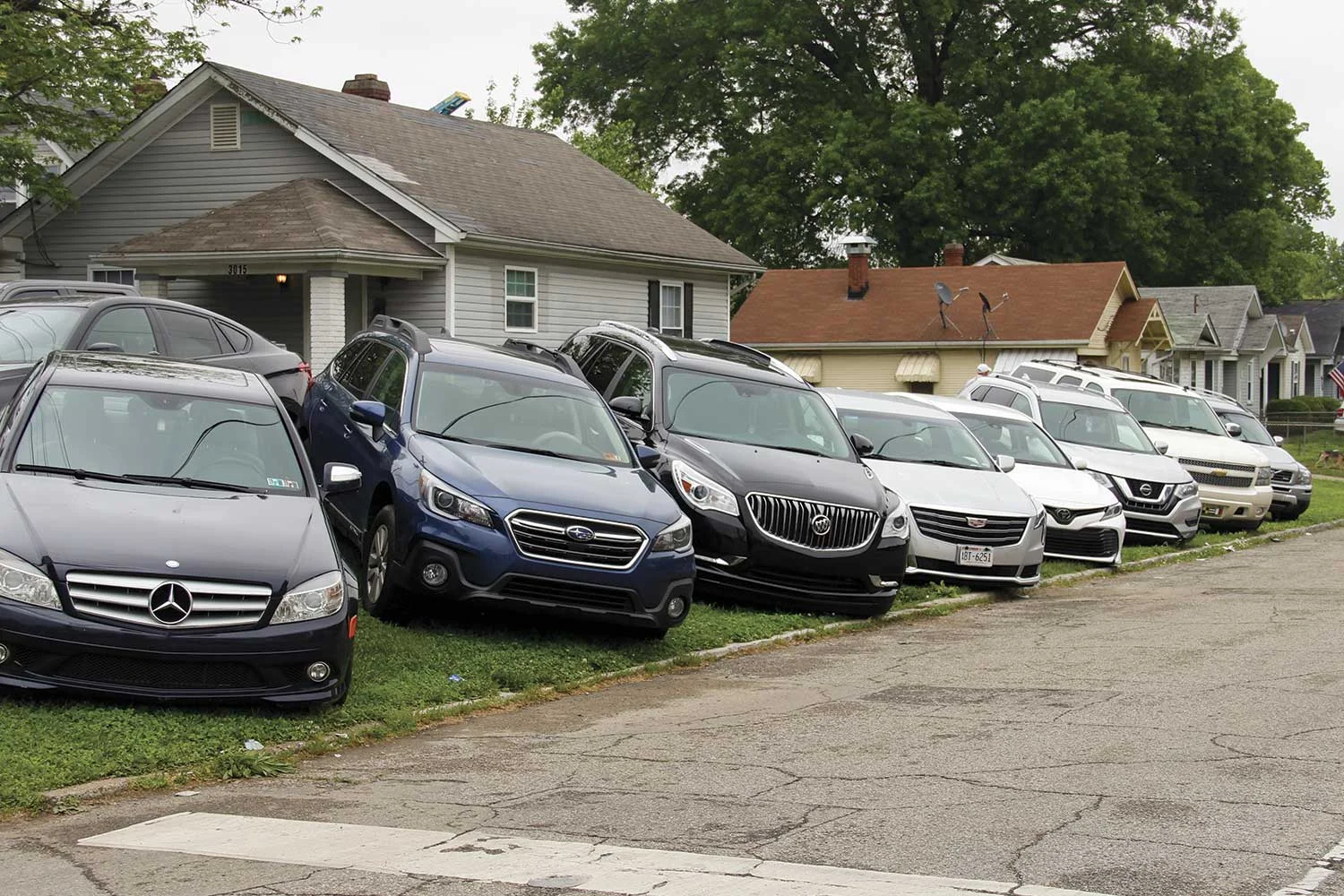 Parking at the Kentucky Derby is hard to come by. Residential areas near Churchill Downs are routinely turned into paid parking lots for those attending the Derby. (Photo by Michael A. Moore)