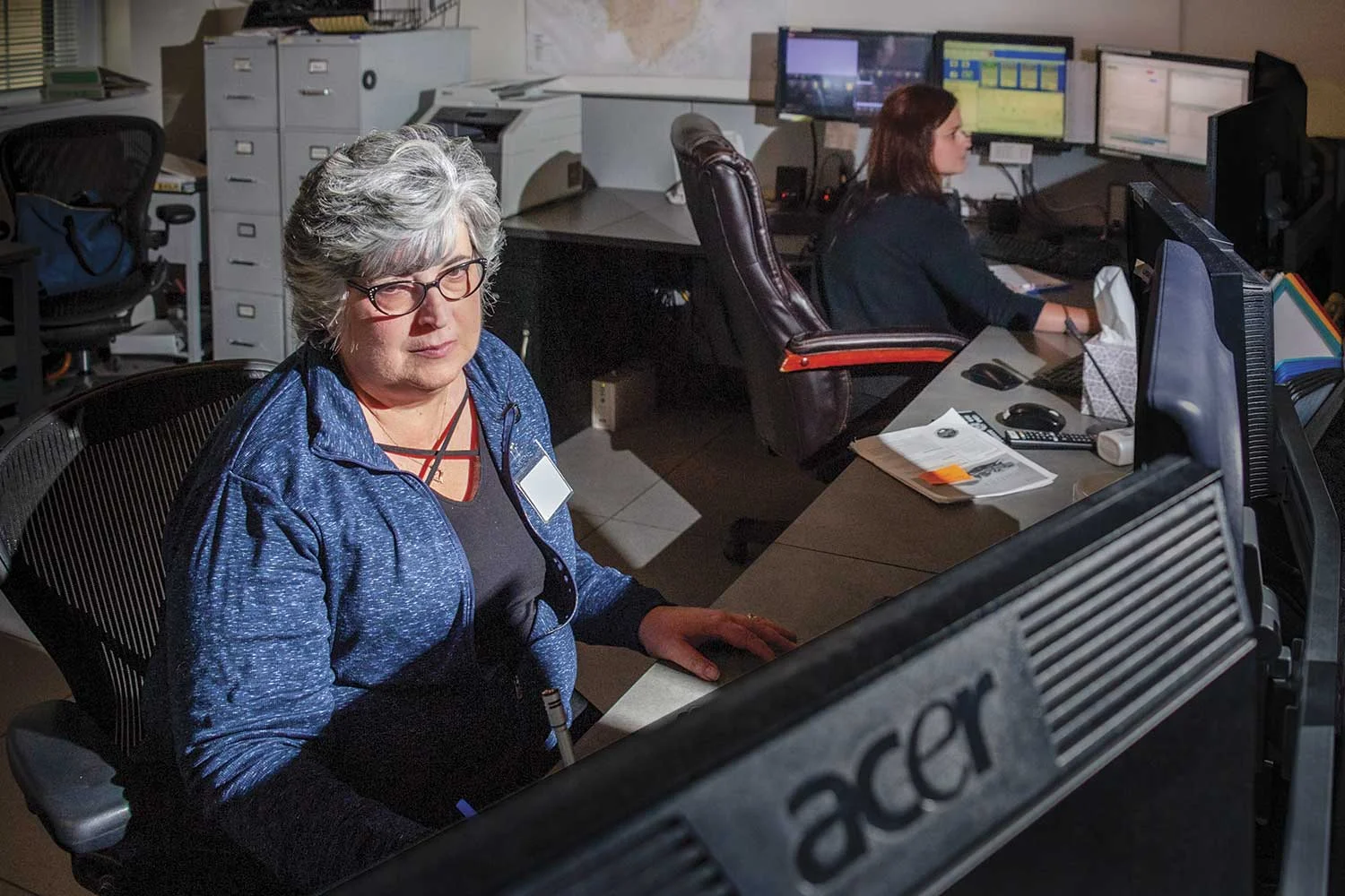 Lisa Richardson, St. Matthews Communications Supervisor, is proud of the customer service her team provides the small community. If someone says there is an emergency at the corner by the laundry mat, she knows exactly where they are located. Pictured in back, dispatcher Jennifer Newman answers calls. (Photo by Jim Robertson)