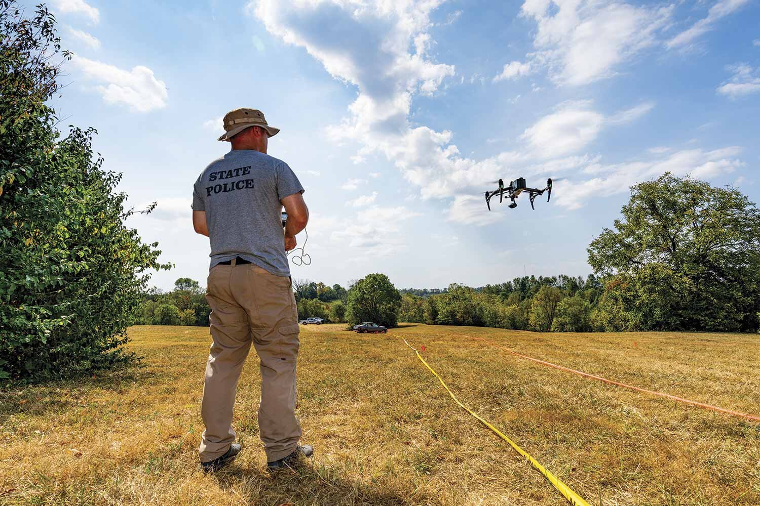  Kentucky State Trooper Jack Hedges pilots a drone, one of the newest tools utilized in crime scene mapping, during a Kentucky Criminalistics Academy field training. (Photo by Jim Robertson) 