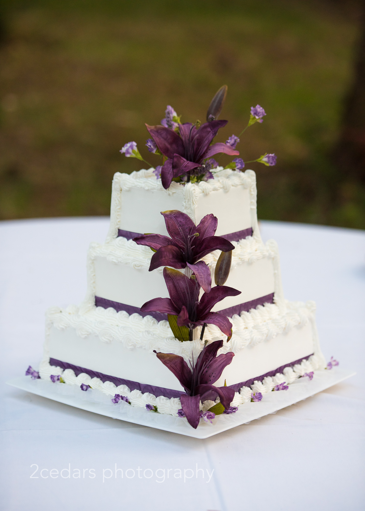 Purple lily wedding cake Pacific Northwest outdoor wedding