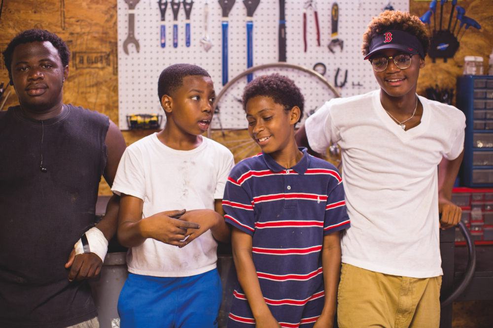  ABOVE: Jquare Smith, 16, Justin Carter, 13, Tremain Gary, 11, and Jadin Lewis, 15, hang out at the shop on Saturdays.