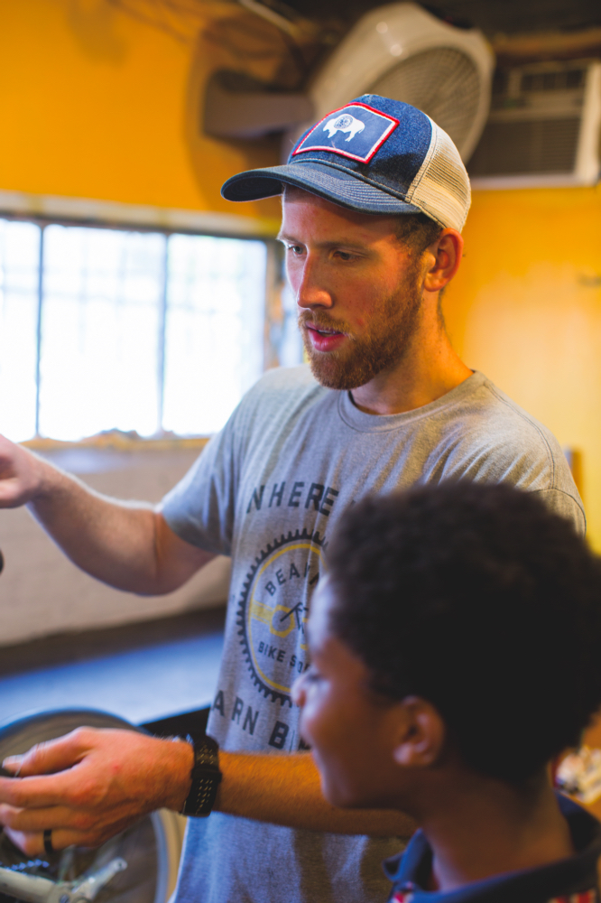 ABOVE: Volunteer Taylor Vaughan works with Tremain Gary, 11.