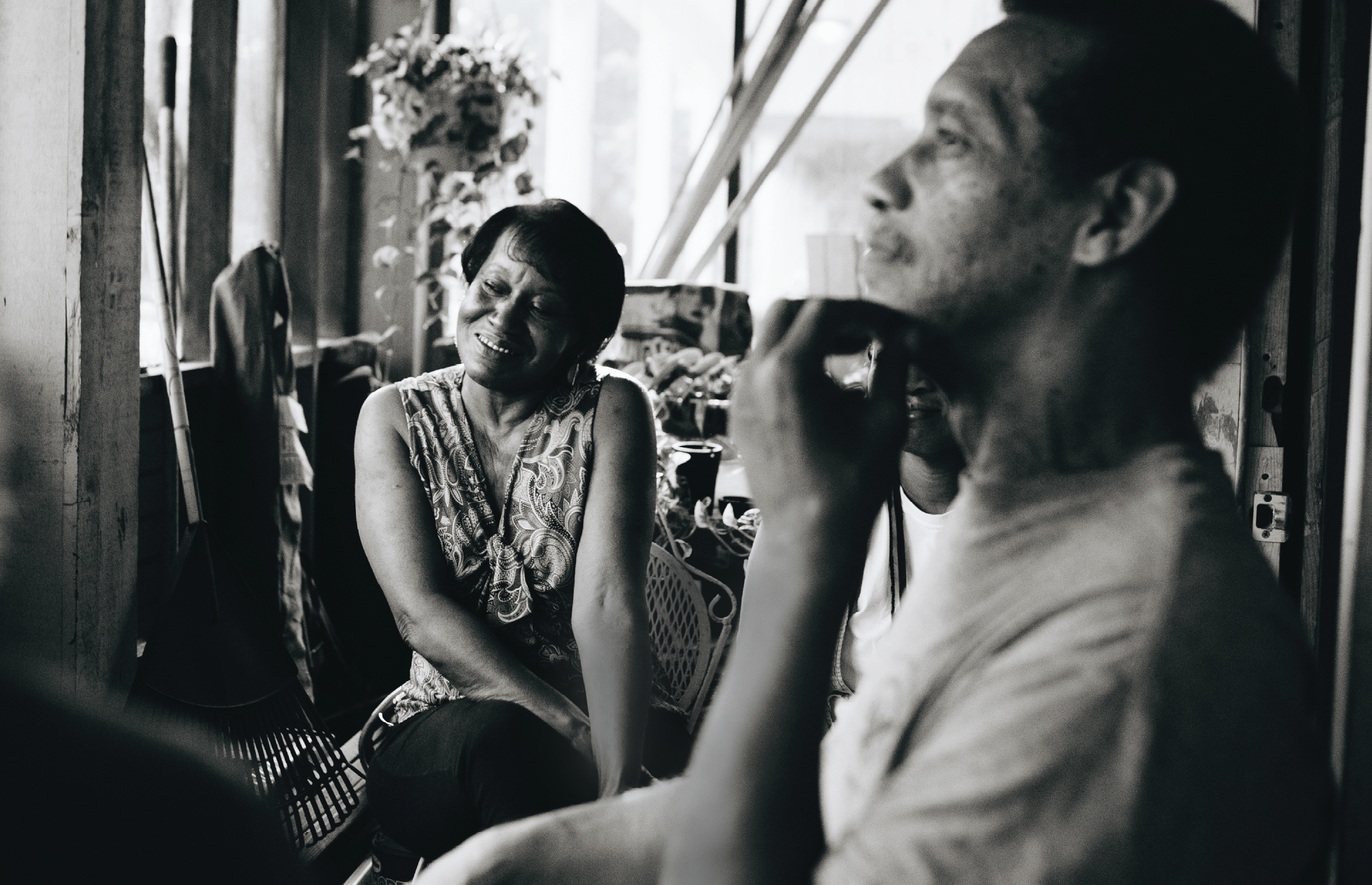 Gregory and Gwendolyn Burson sit on the front porch of their Peoplestown home.