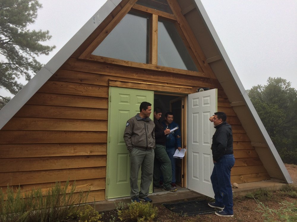 Discussing possible defensible space options for structures at Camp Stoney, located in the Greater Santa Fe Fireshed.