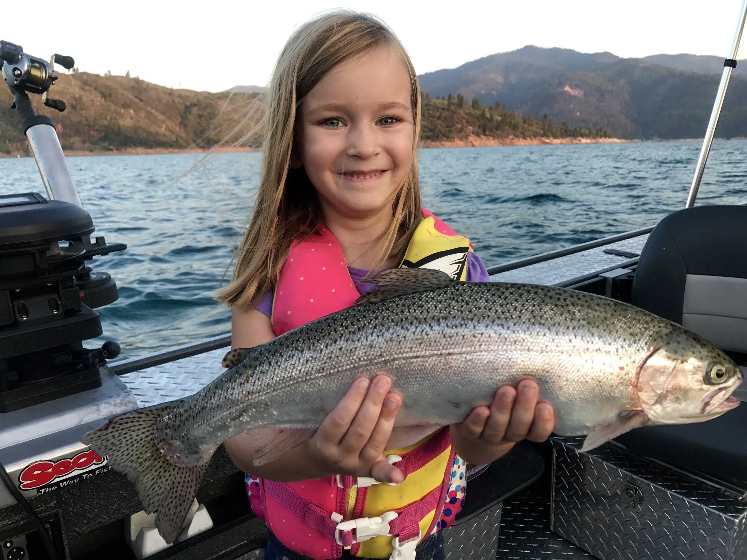 Gracie showing off one of her Shasta Lake rainbows she caught this week!