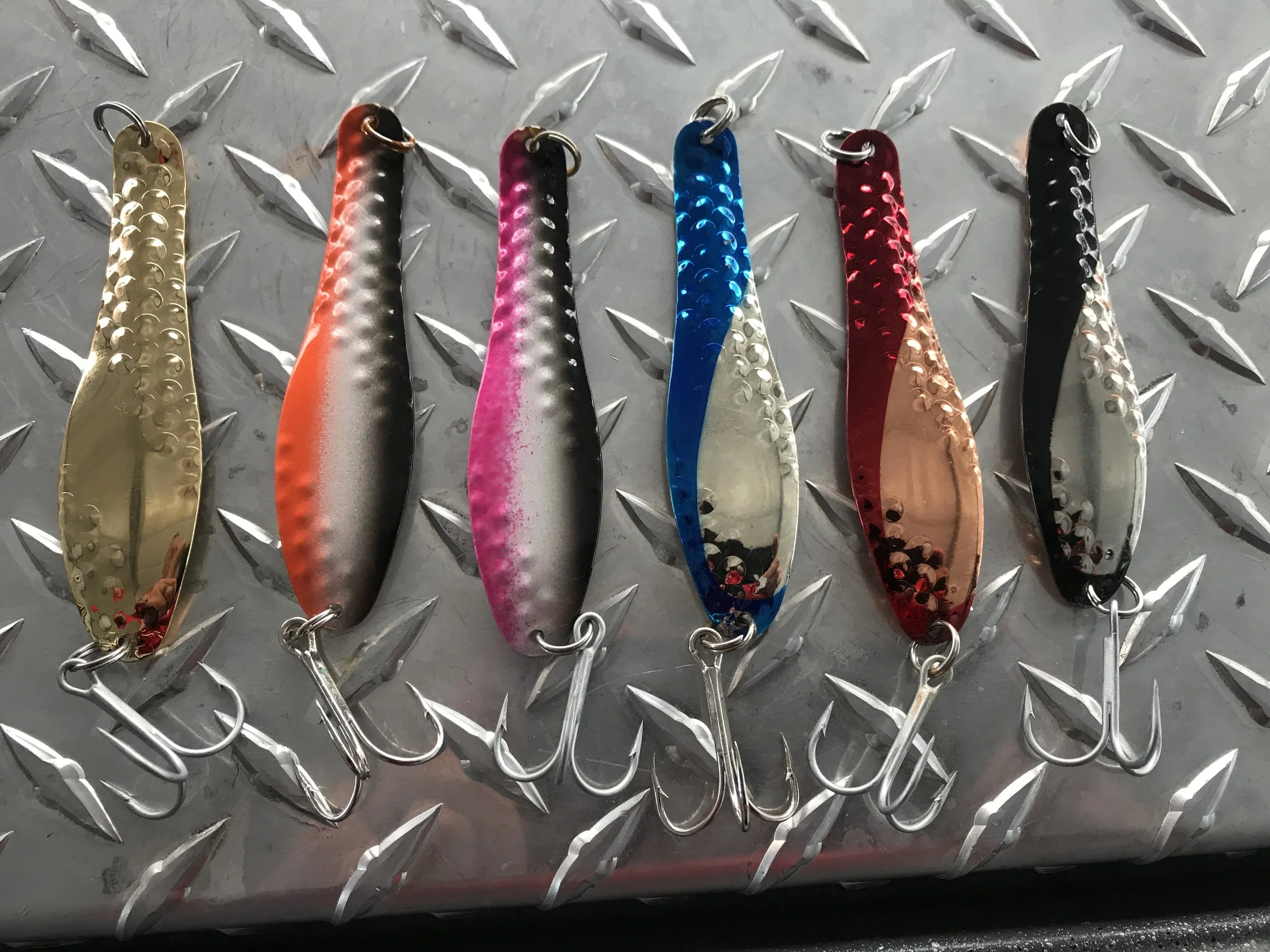 Optimizer spoons come in dozens of colors and two sizes. These are just a few of the finishes I have on my boat for chasing big Shasta Lake trout.