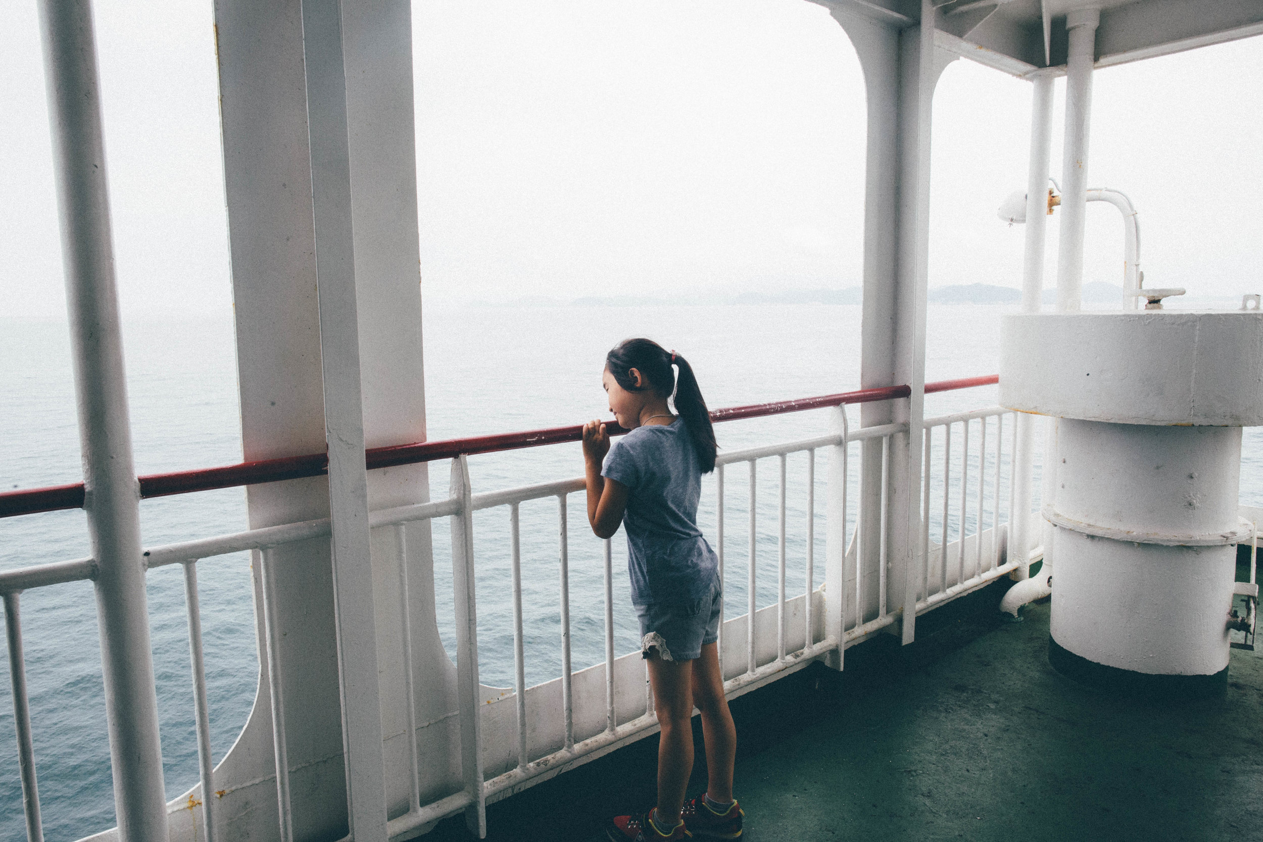   A young girl rides the Hanil Express Ferry to Jeju Island. Jeju-do, South Korea.&nbsp;  