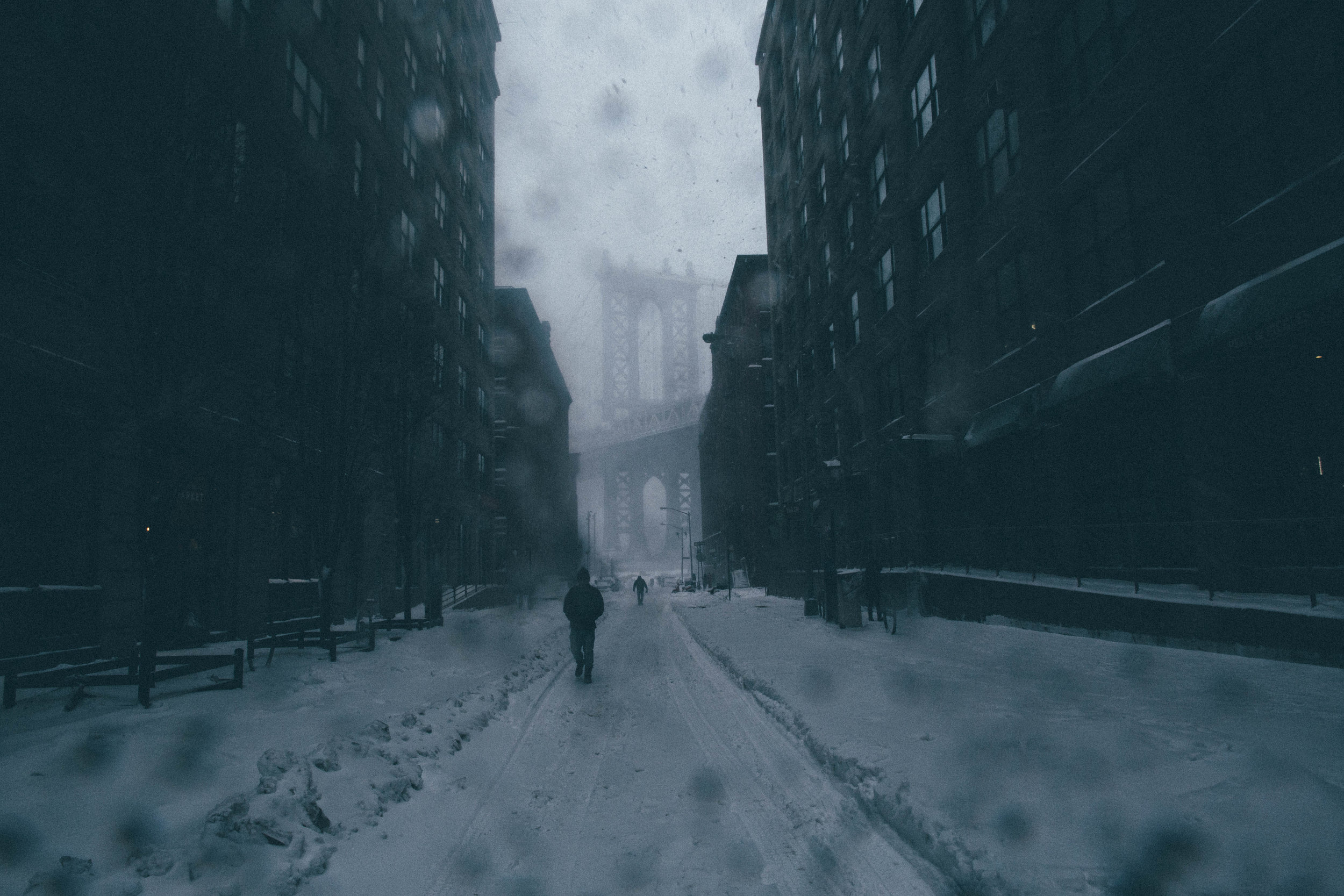   Pedestrians traverse the snowy streets of DUMBO during Blizzard Jonas. Brooklyn, New York.&nbsp;  