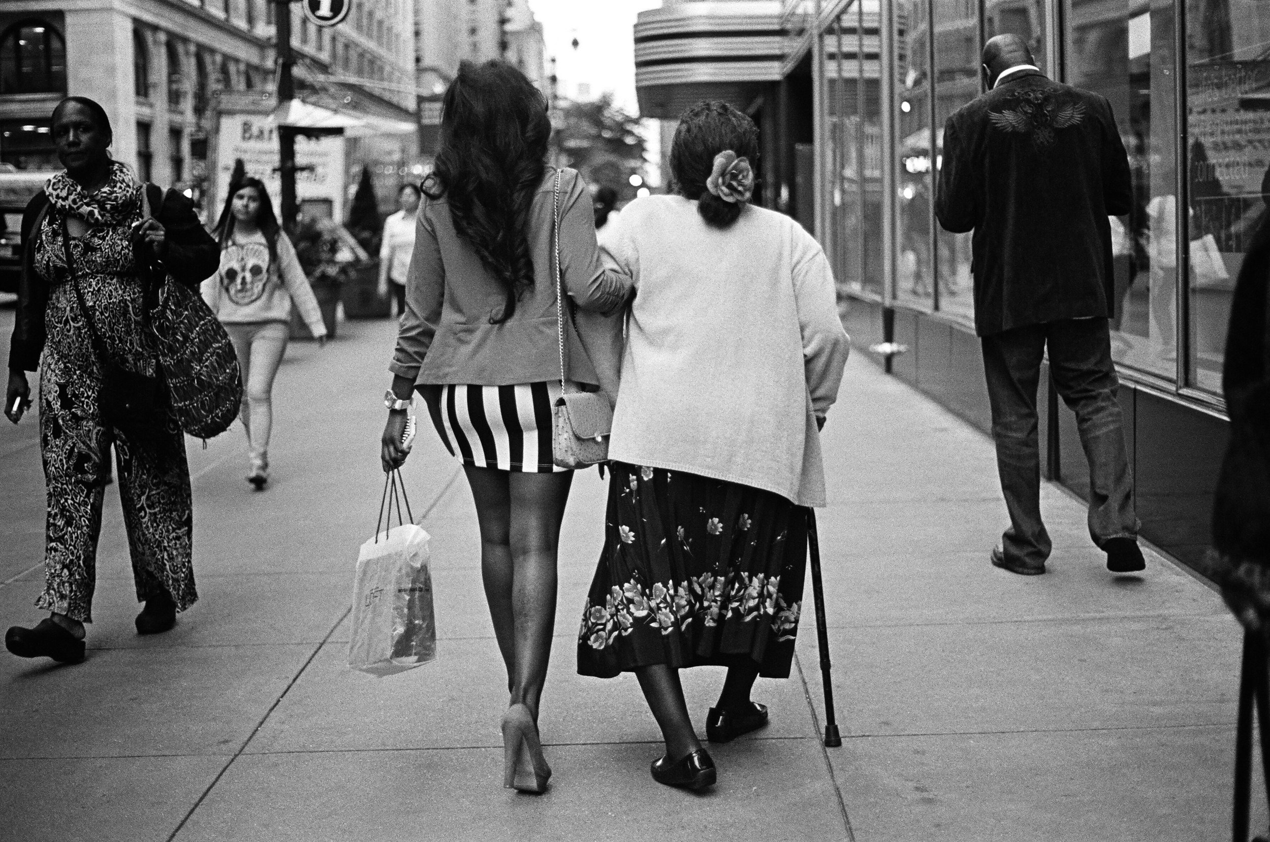   A granddaughter helps her grandmother down 34th Street.&nbsp;  