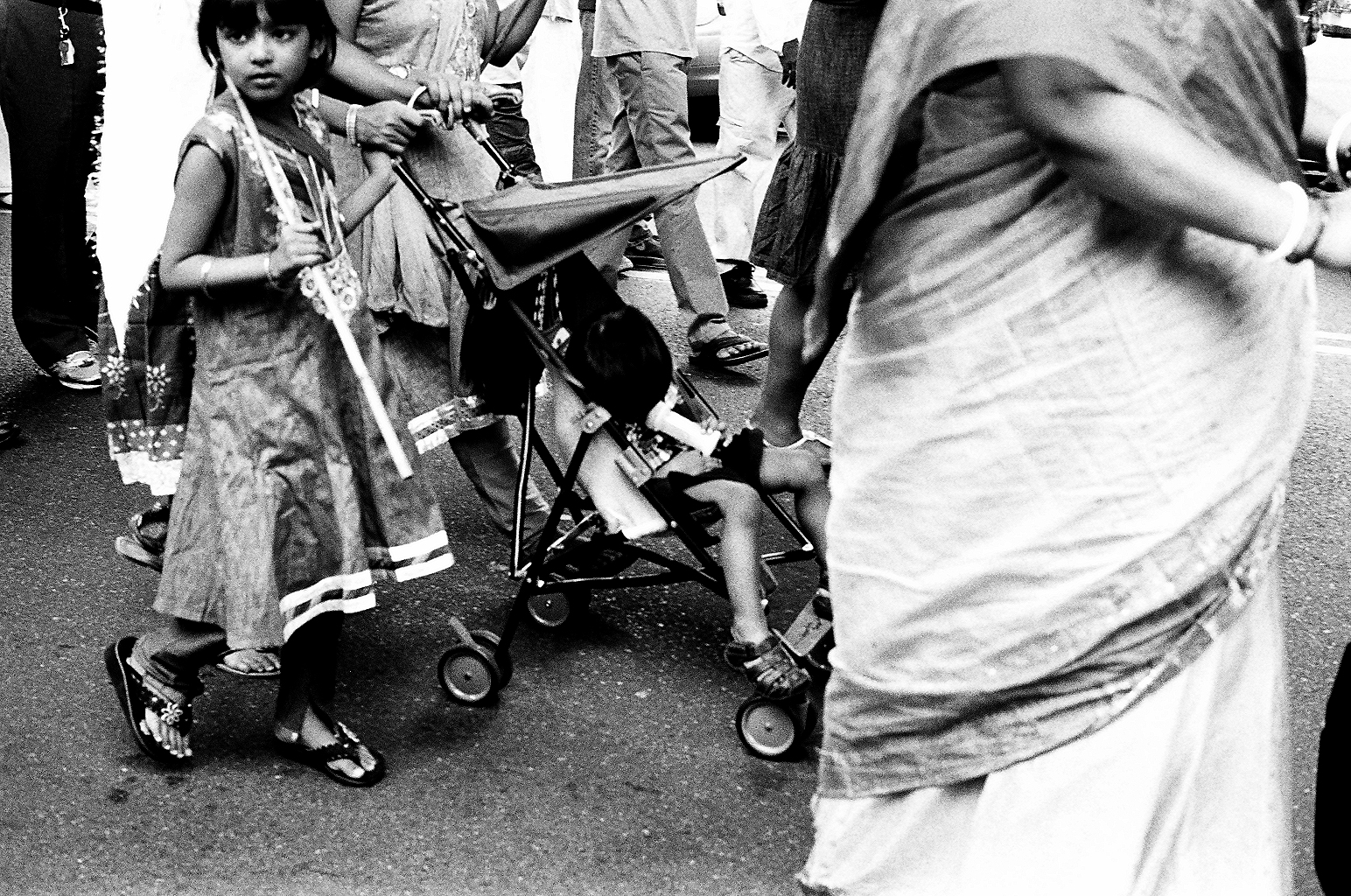   Distracted kids during a Ratha Yatra procession in Richmond Hill   