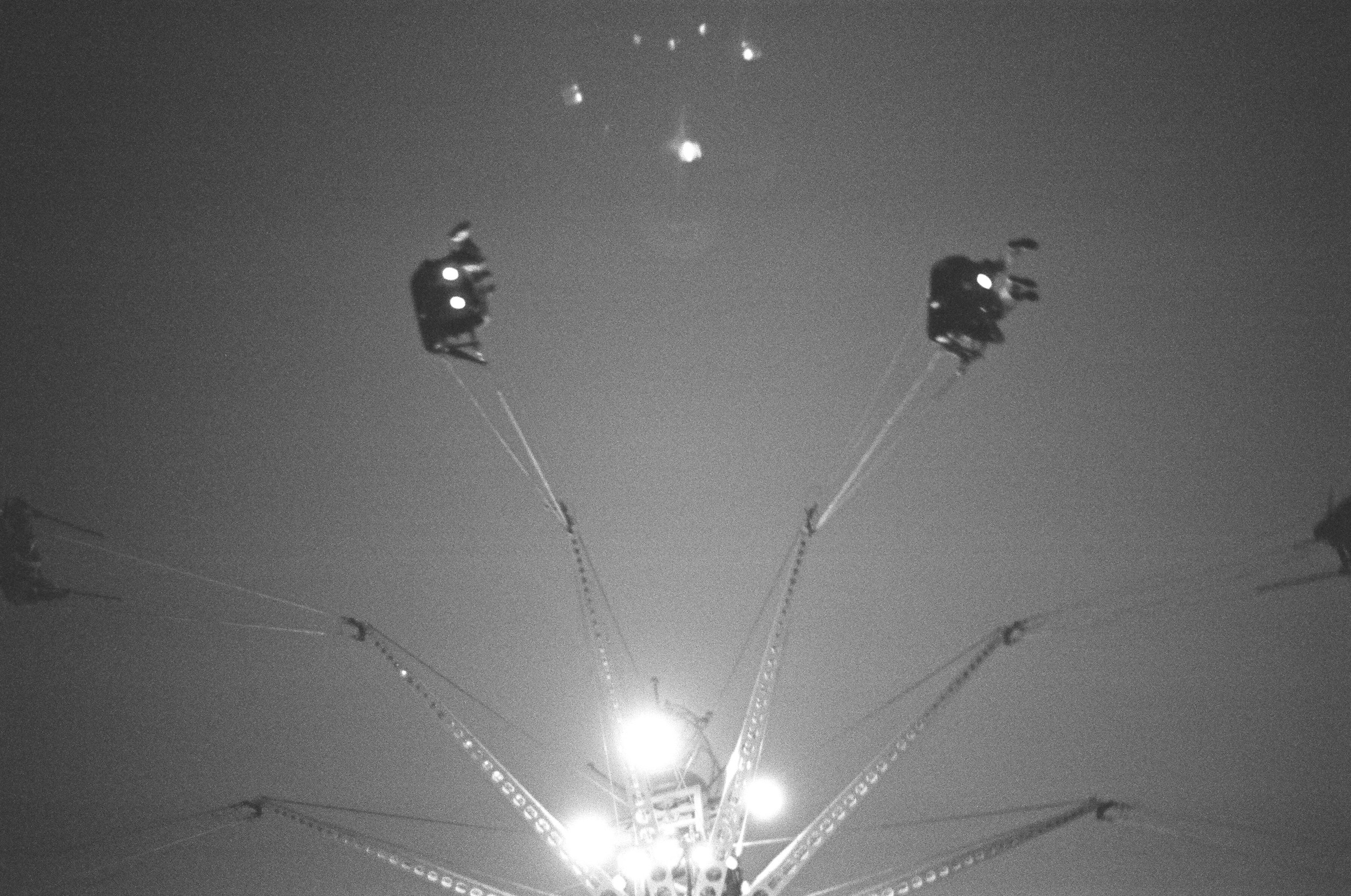 Amusement park goers ride the Brooklyn Flyer over Coney Island