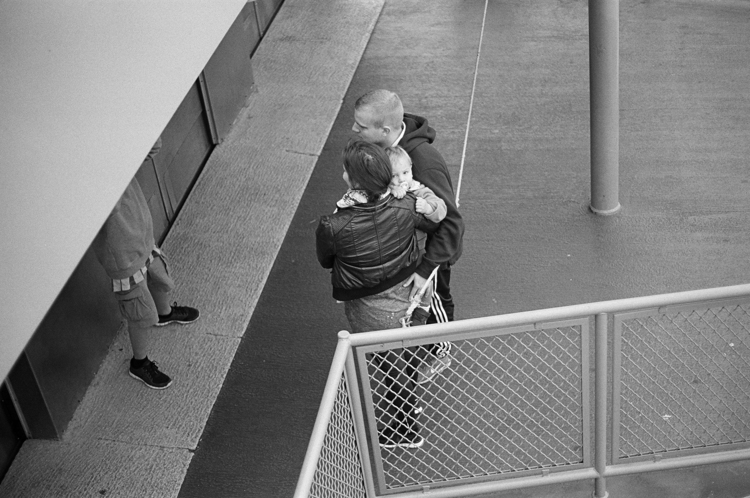 A child looks away from a family portrait on the Staten Island Ferry