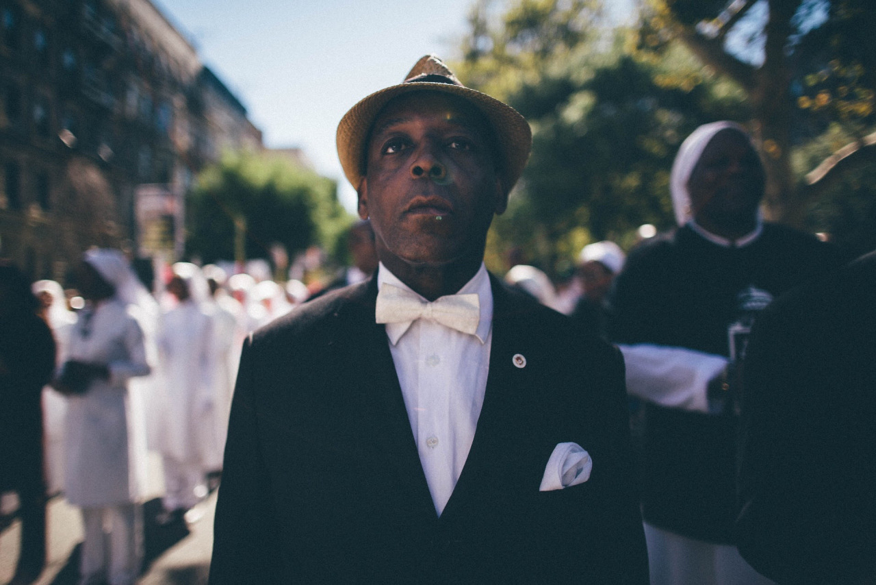 A man from the Nation of Islam prepares to march in the African-American Day Parade. Harlem, New York. 