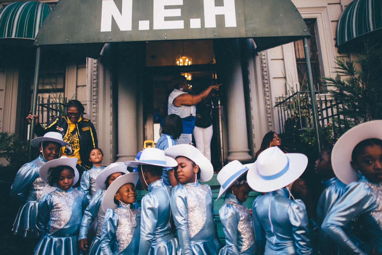   A dance troupe from New Jersey gathers before a performance in front of the New Ebony Hotel on West 112th Street. Harlem, New York.&nbsp;  