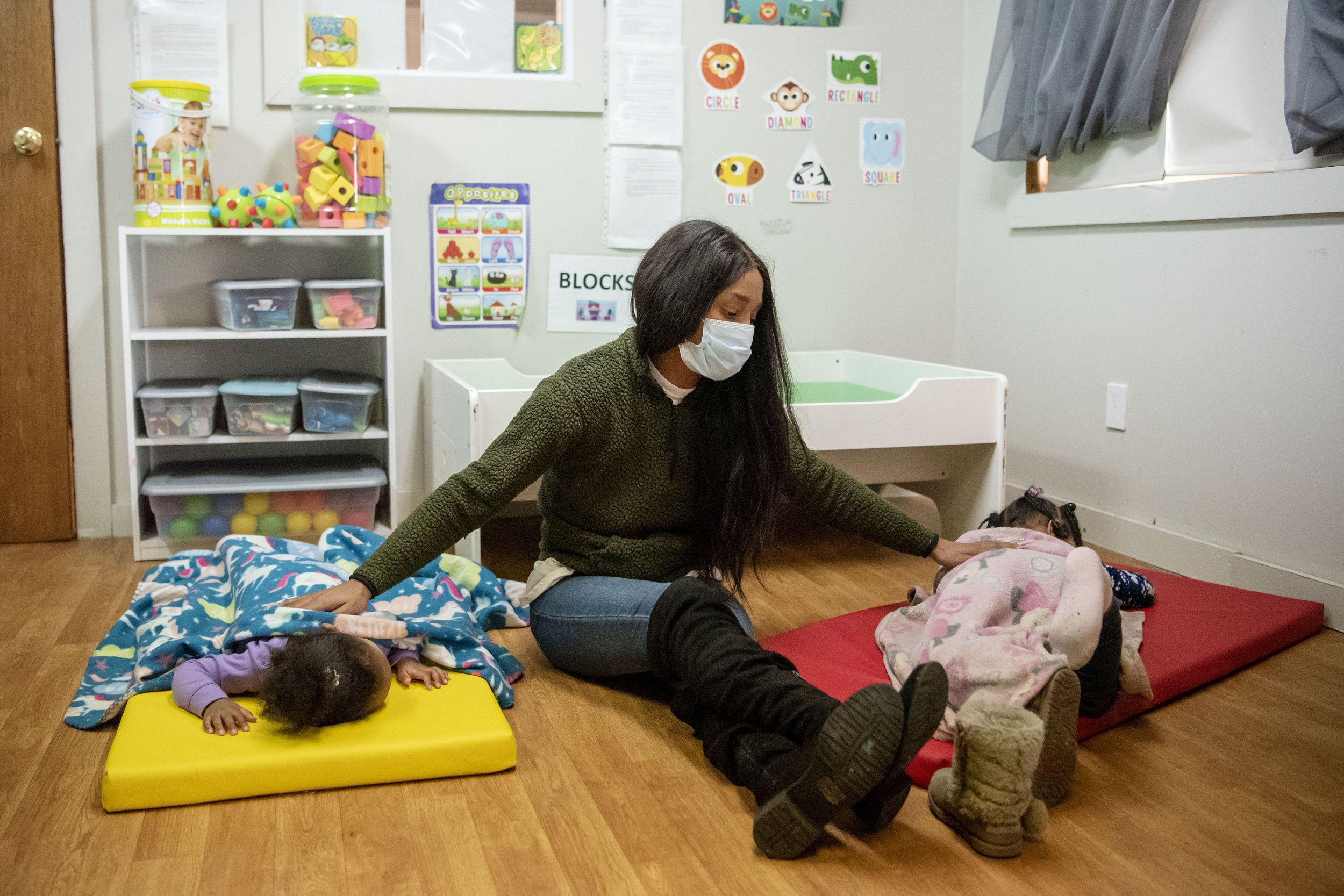  Program director Nita Hinton settles Legacy Cole, 1, and Karsyn McNutt, 3, down for a nap at Lens Learning Center in Battle Creek, Michigan on Monday, March 1. Hinton established the 24-hour daycare with the goal of enhancing access to childcare ser