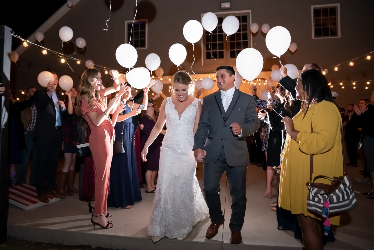 bride-groom-wedding-exit-balloons-glow-nightime-mcgranahanbarn-chadandbriephotography.jpg