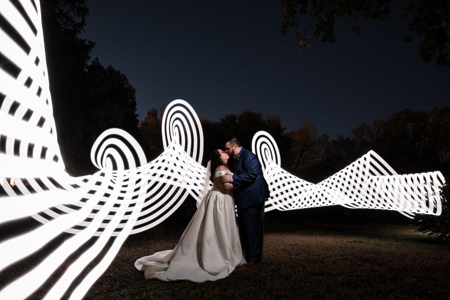 wedding-photographer-photography-okc-edmond-oklahoma-city-beautiful-bride-groom-bridesmaids-groomsmen-bridal-party-portrait-night-sky-light-paint-white-lines-chadandbriephotography.jpg
