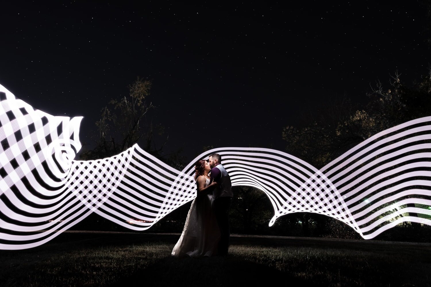 wedding-photographer-photography-okc-edmond-oklahoma-city-beautiful-bride-groom-bridesmaids-groomsmen-bridal-party-portrait-night-sky-light-paint-stars-lines-chadandbriephotography.jpg