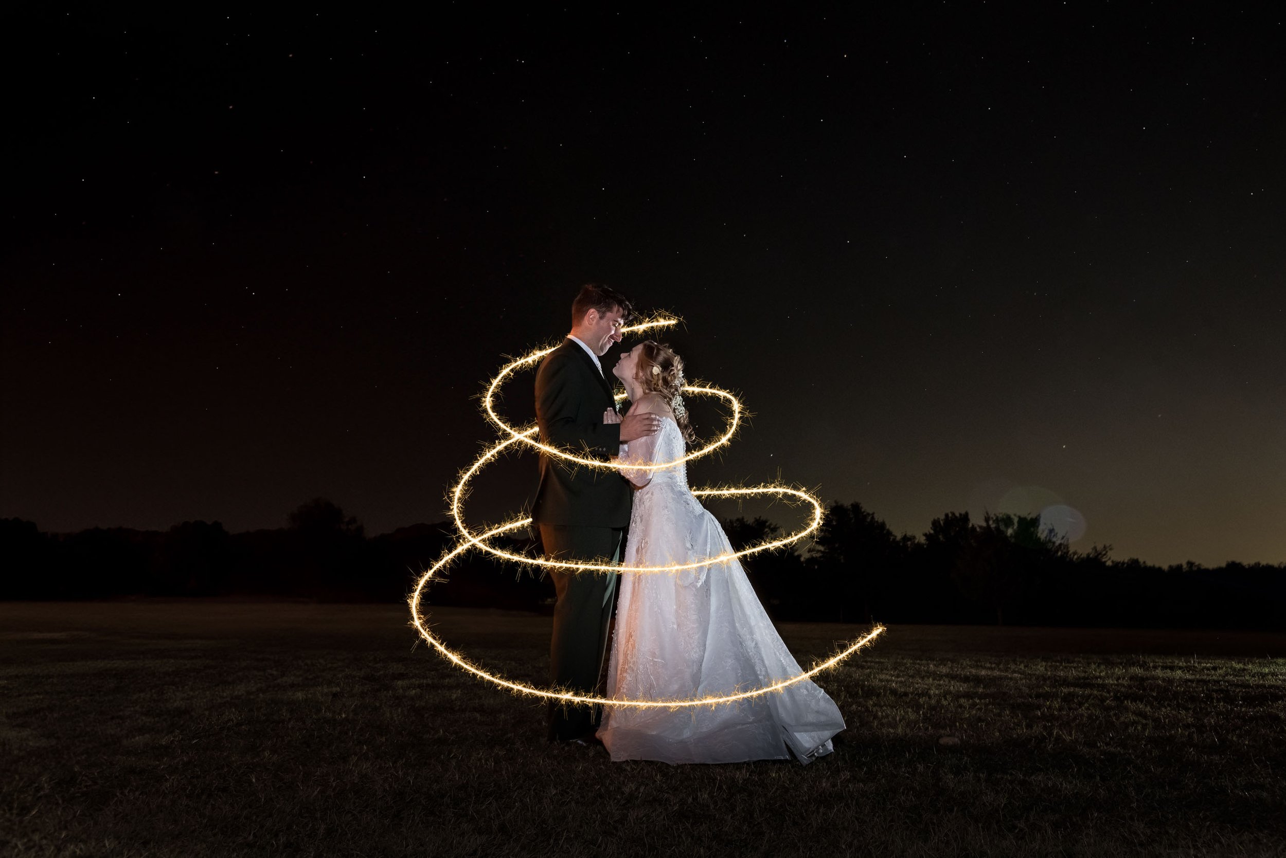 wedding-photographer-photography-okc-edmond-oklahoma-city-beautiful-bride-groom-night-portrait-sparkler-circle-stars-chadandbriephotography.jpg