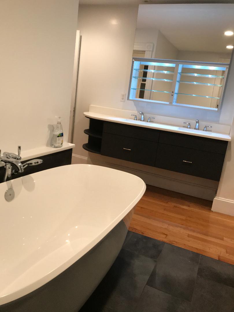  Custom built vanity. White Quartz countertop with Perrin Rowe dual faucets. Robern medicine cabiet. The door levitates up to open access within. 