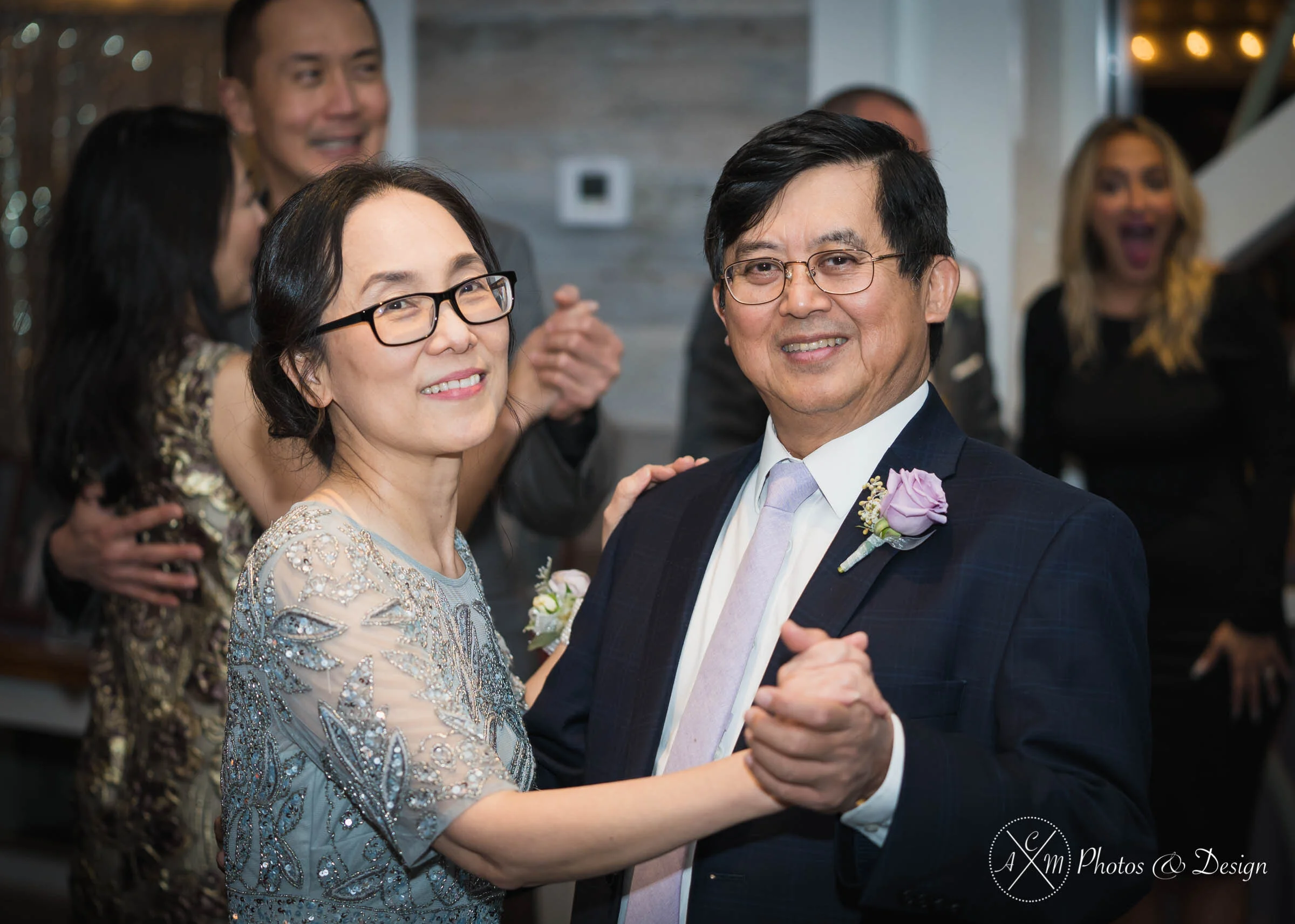 Using speed lights on our cameras and a globe-we bounced the light off the ceiling to capture this sweet moment of a mother and father of the bride dancing the night away!