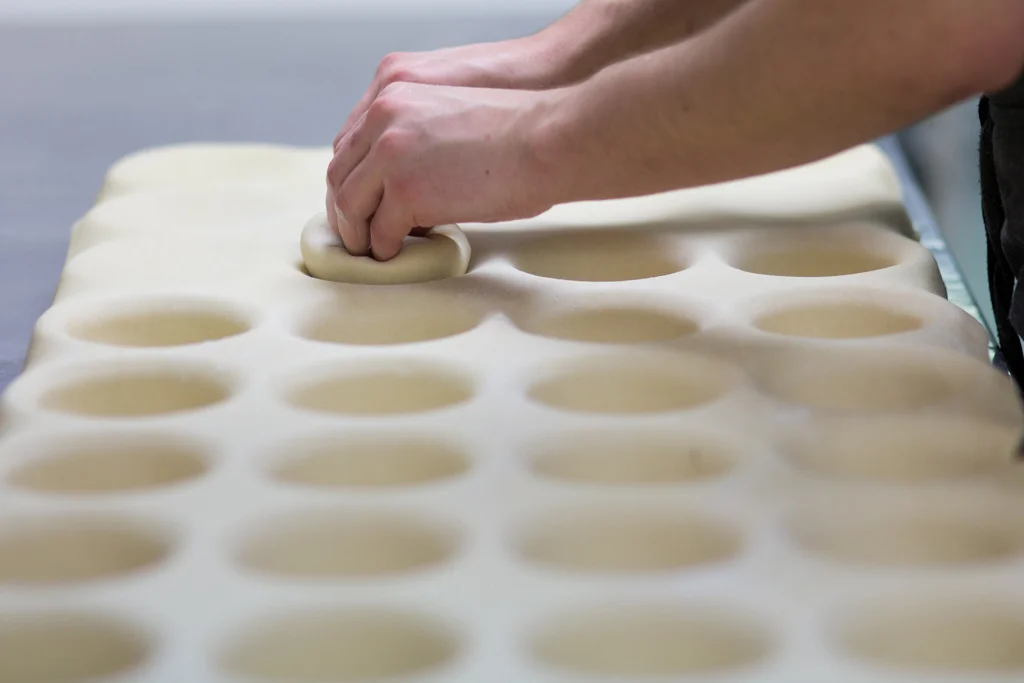 Mapua Village Bakery shaping pie bases.jpg