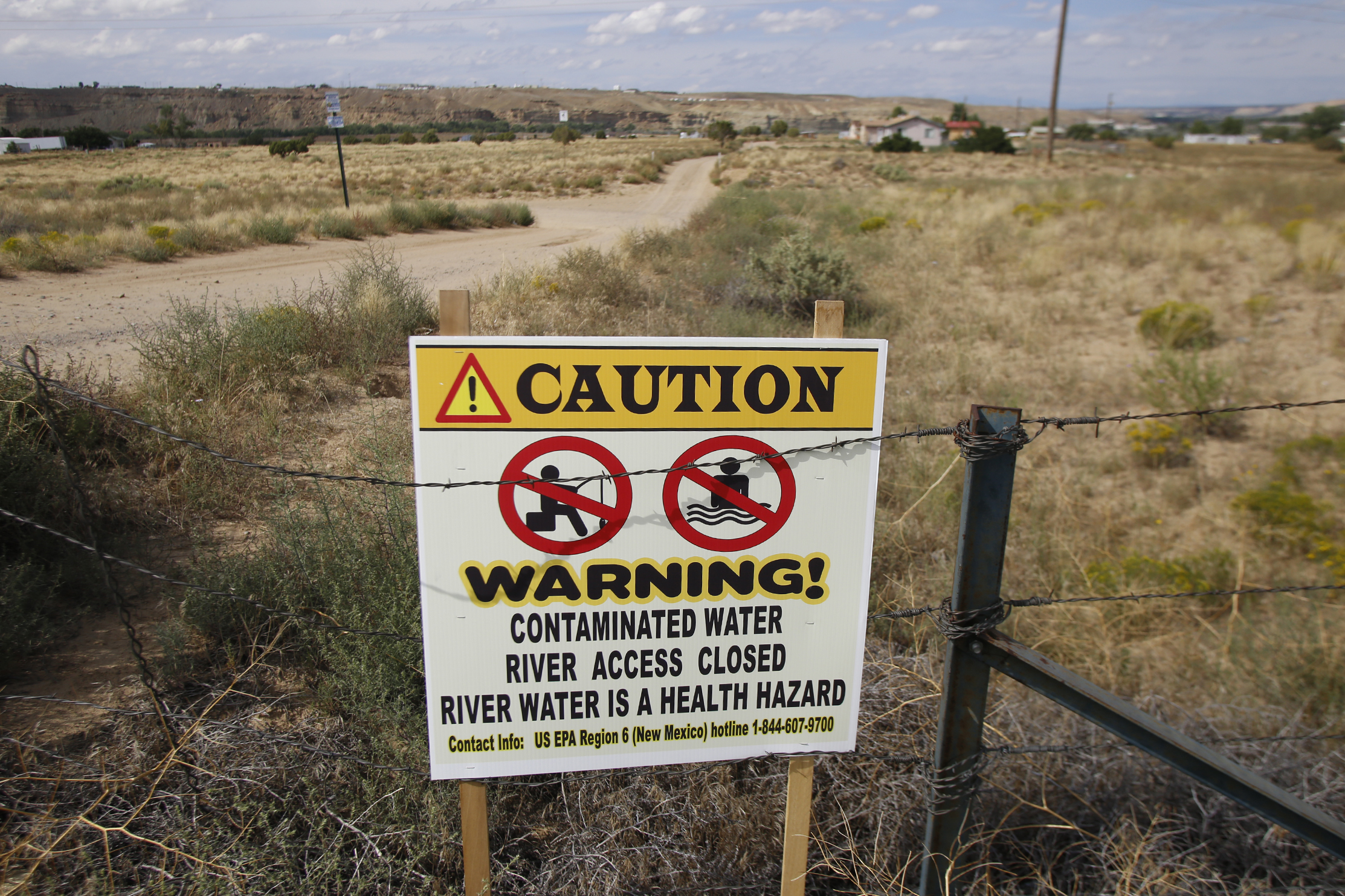 A warning sign is posted near the Fruitland canal, Wednesday, Aug. 26 ,2015, in Upper Fruitland, New Mexico.