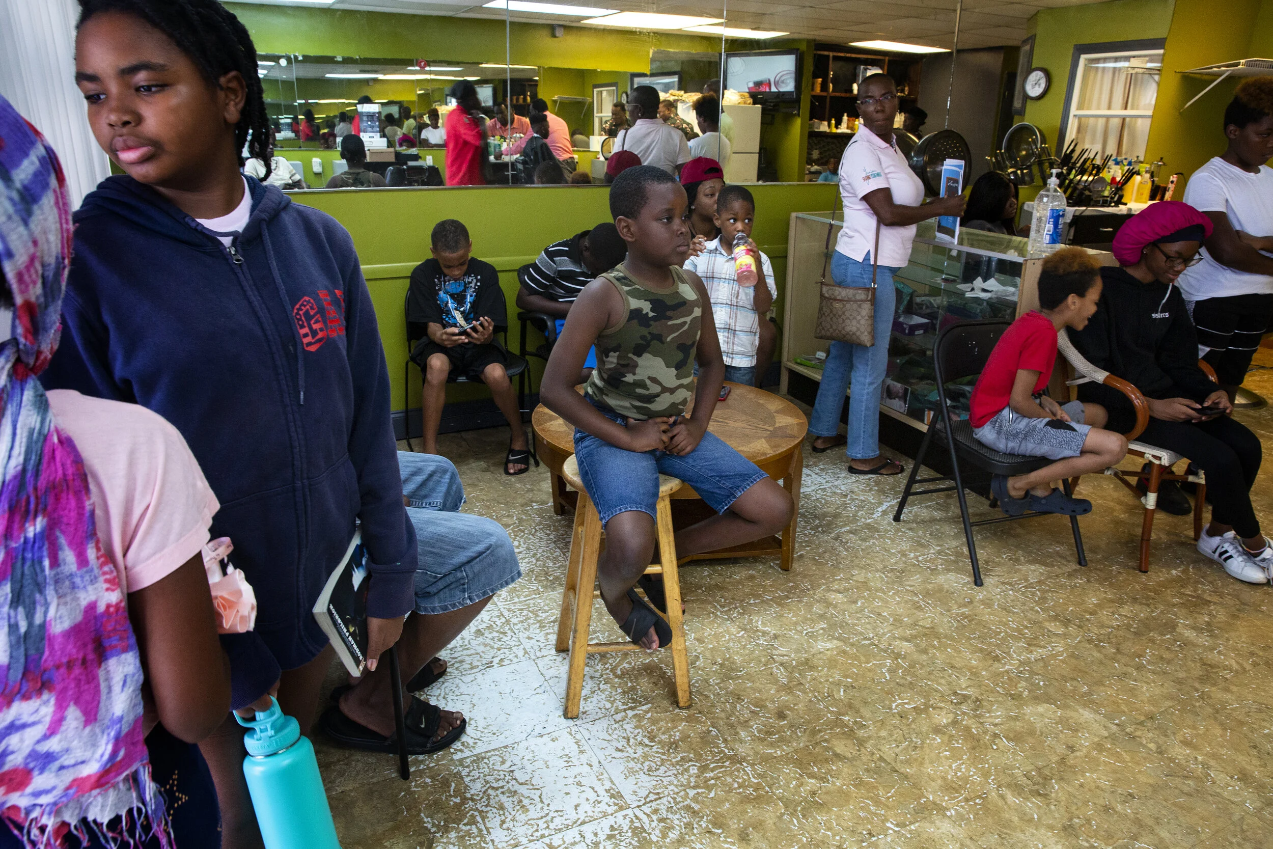 River Park community members wait to receive haircuts during a back to school special, Saturday, Aug. 10, 2019 at Excelsior barber shop in River Park, Florida.  