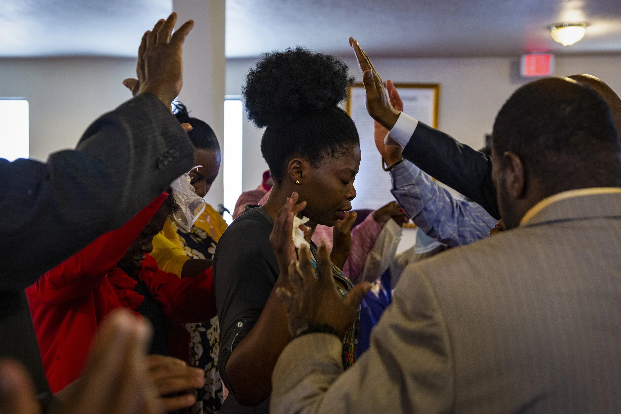  Macedonia Missionary Baptist Church members pray over Zininzi Mkosano, of Johannesburg, South Africa during a church service, Sunday, Oct. 13, 2019, during church service in River Park. 